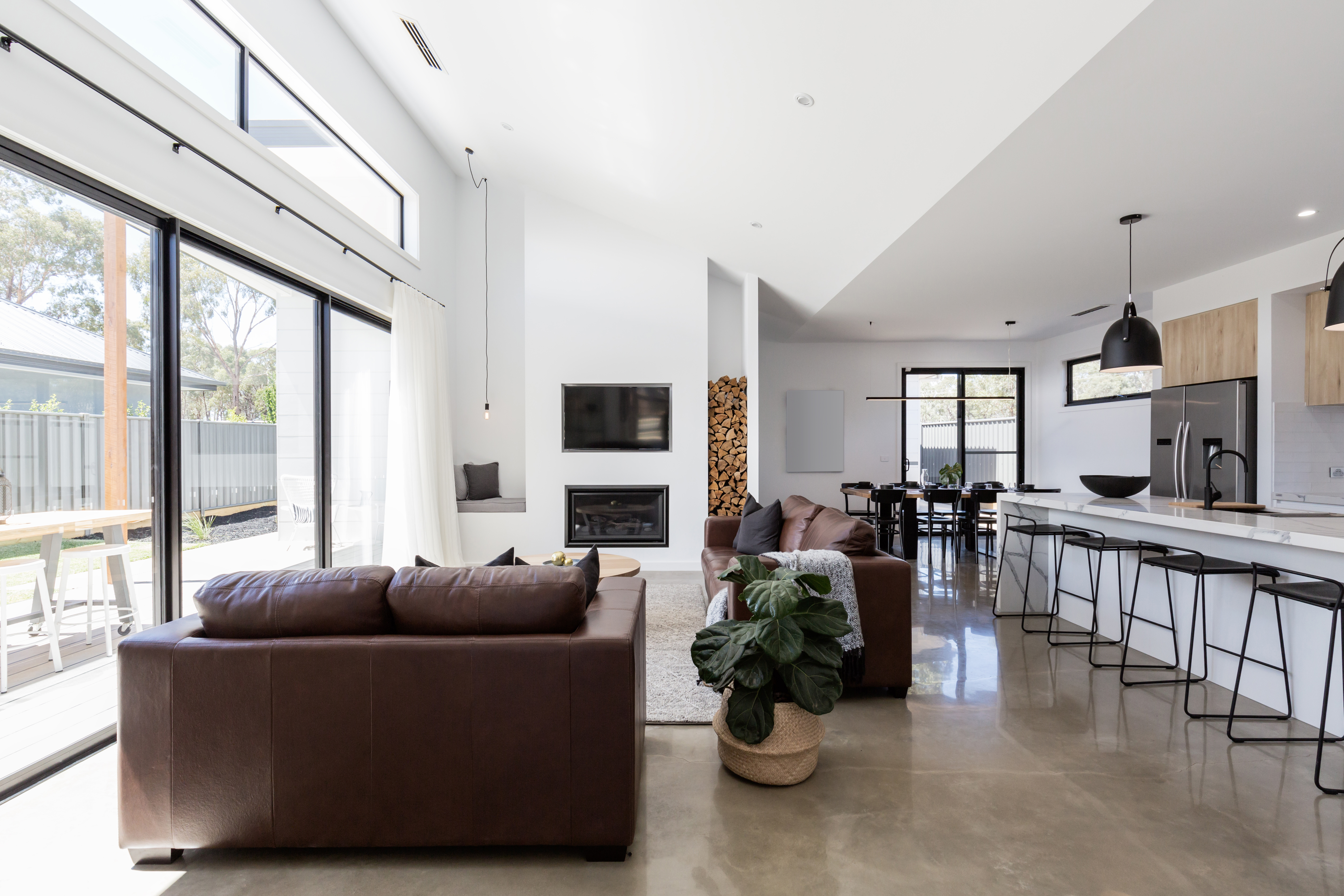 A contemporary living room with concrete flooring