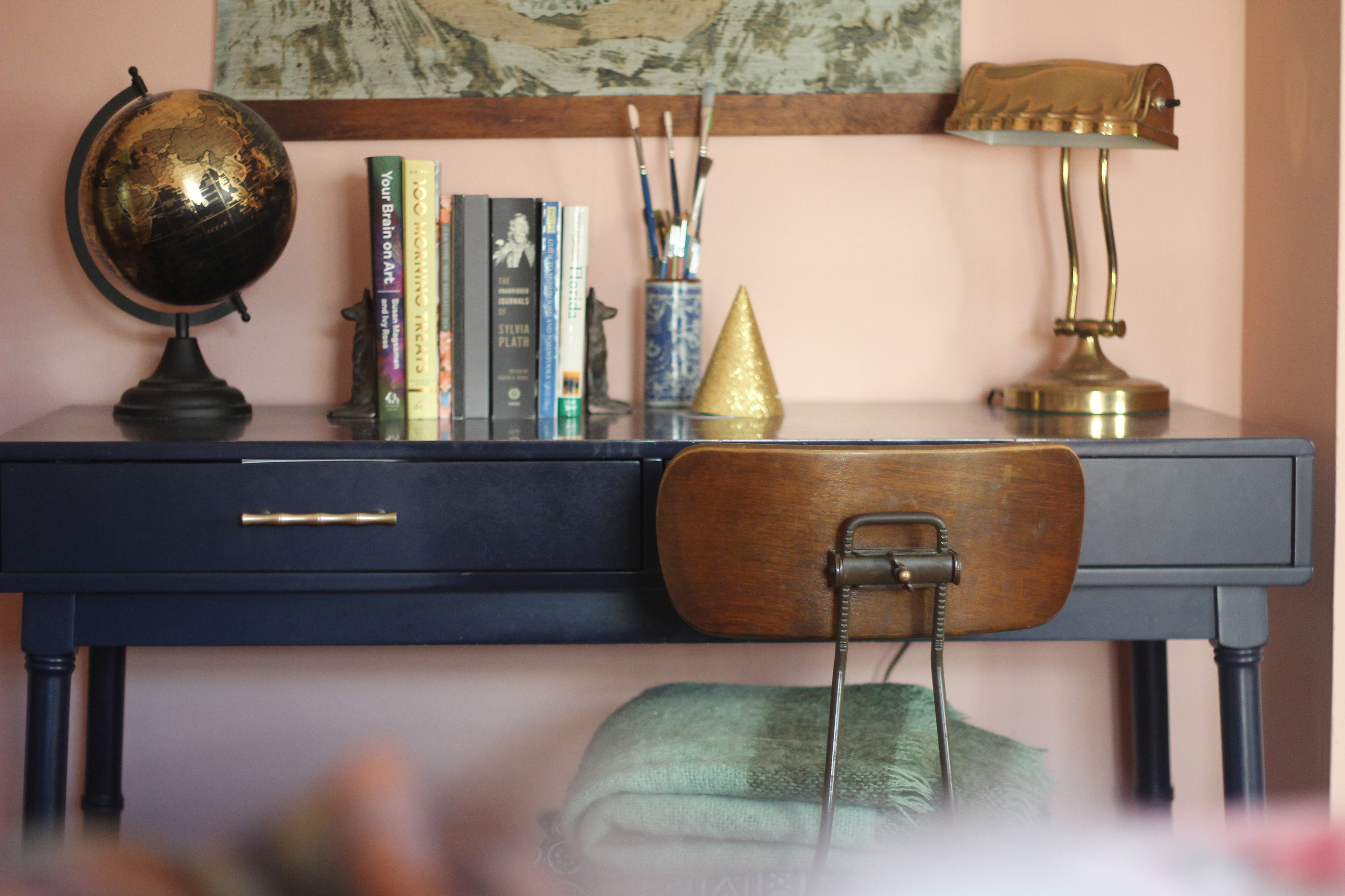 A vintage blue desk with an antique chair