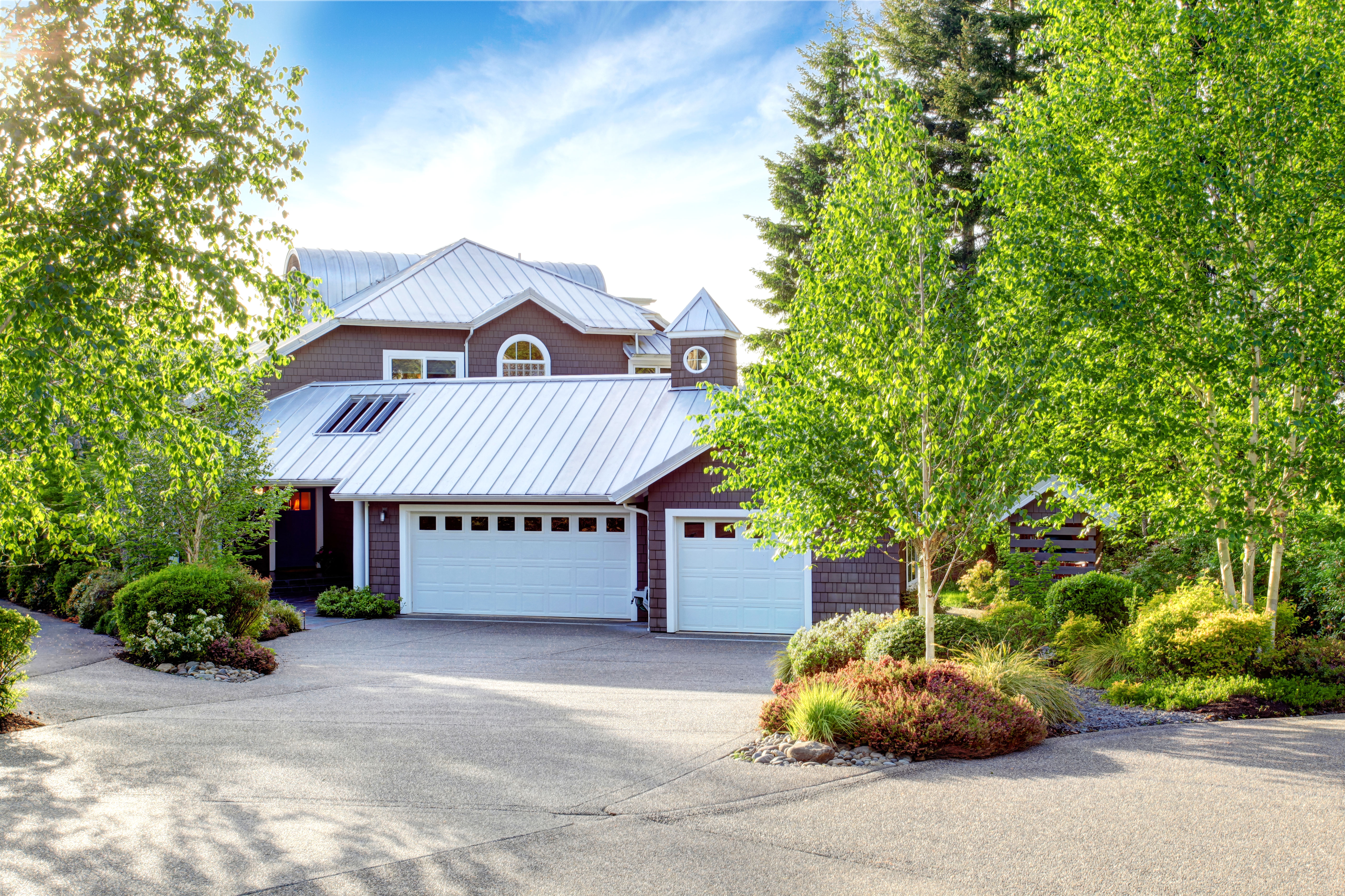 Standing seam metal roof installed in a house surrounded by trees  
