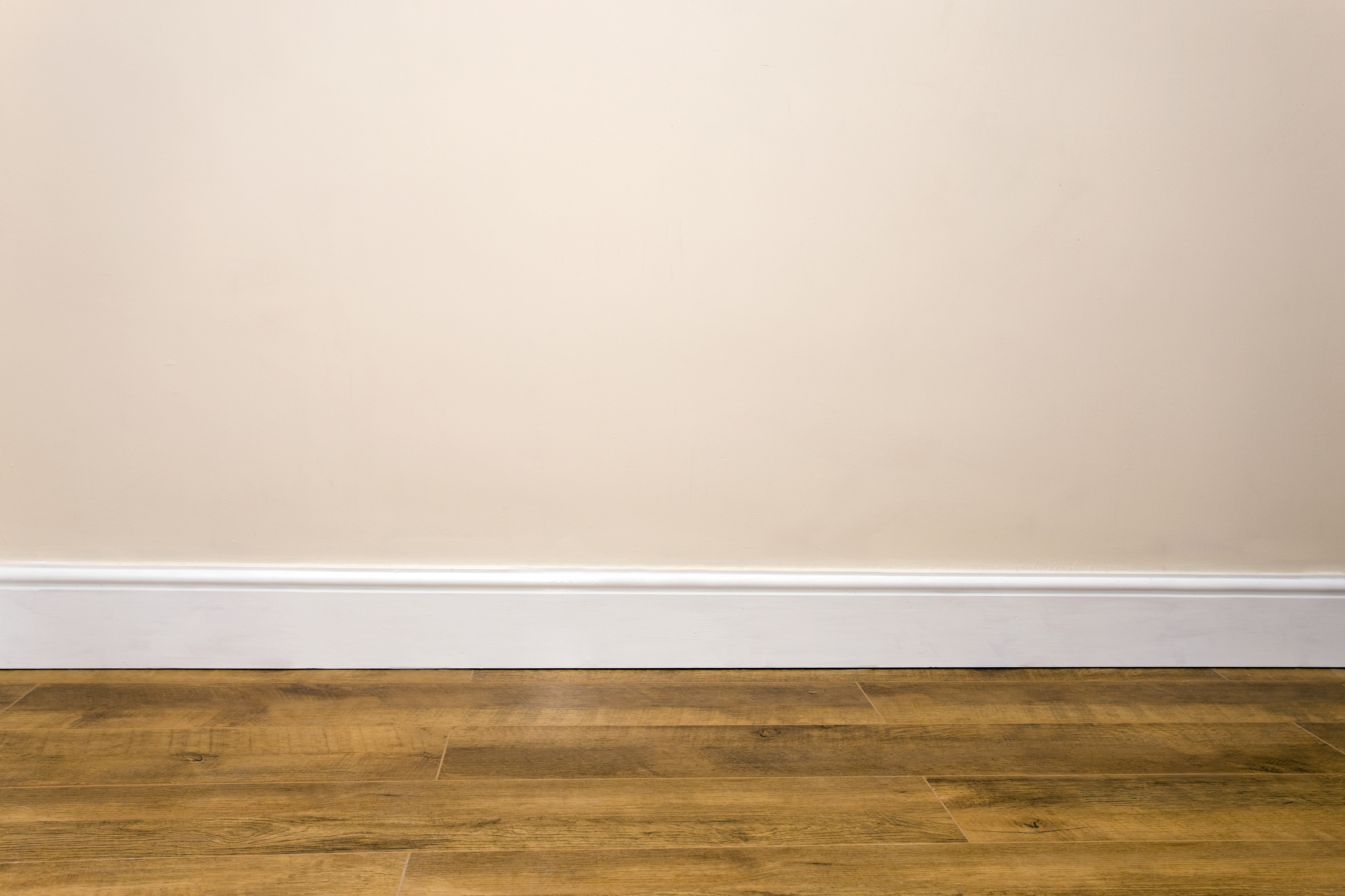 plain wall with a simple white baseboard 