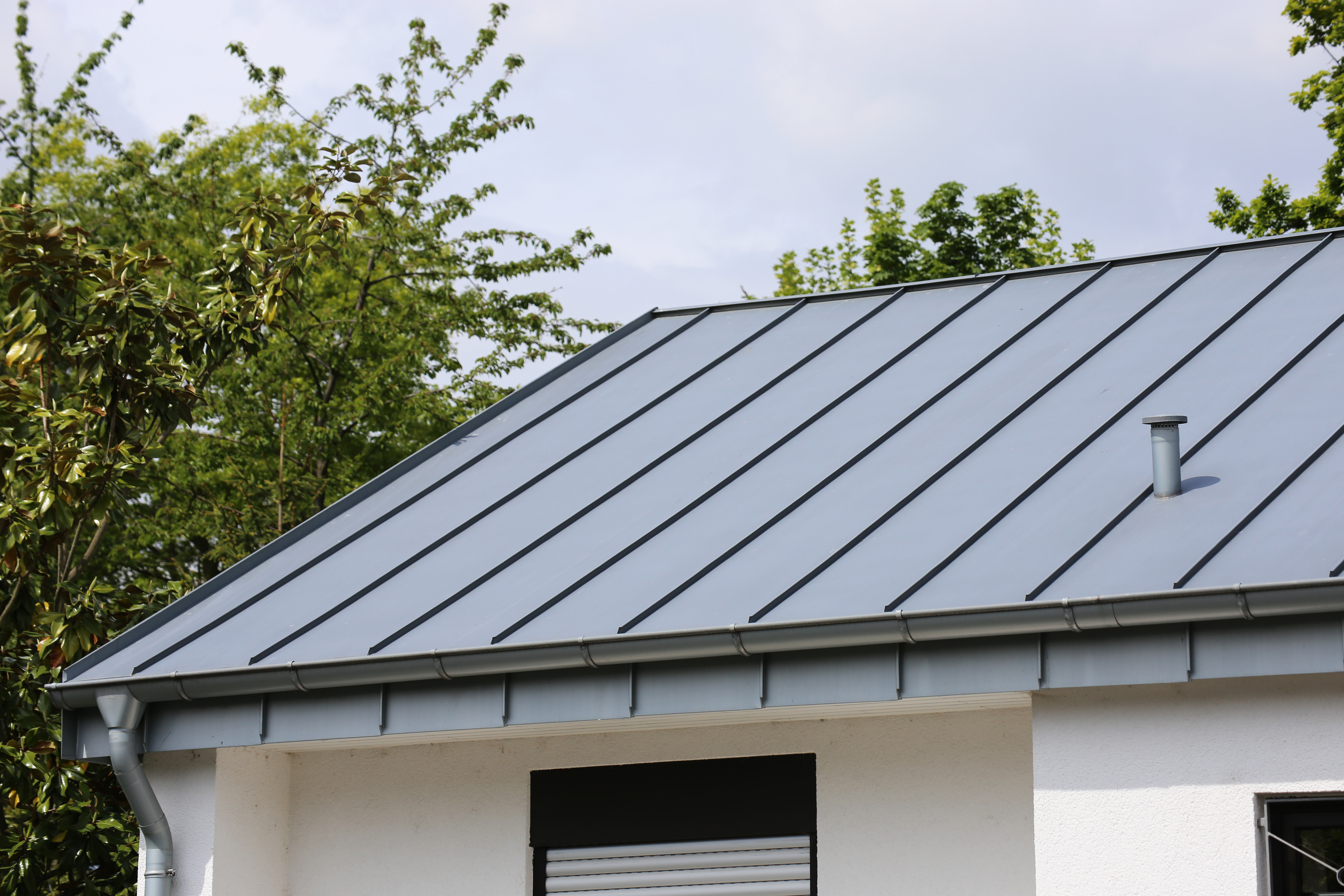 House with a gray standing seam metal roof   