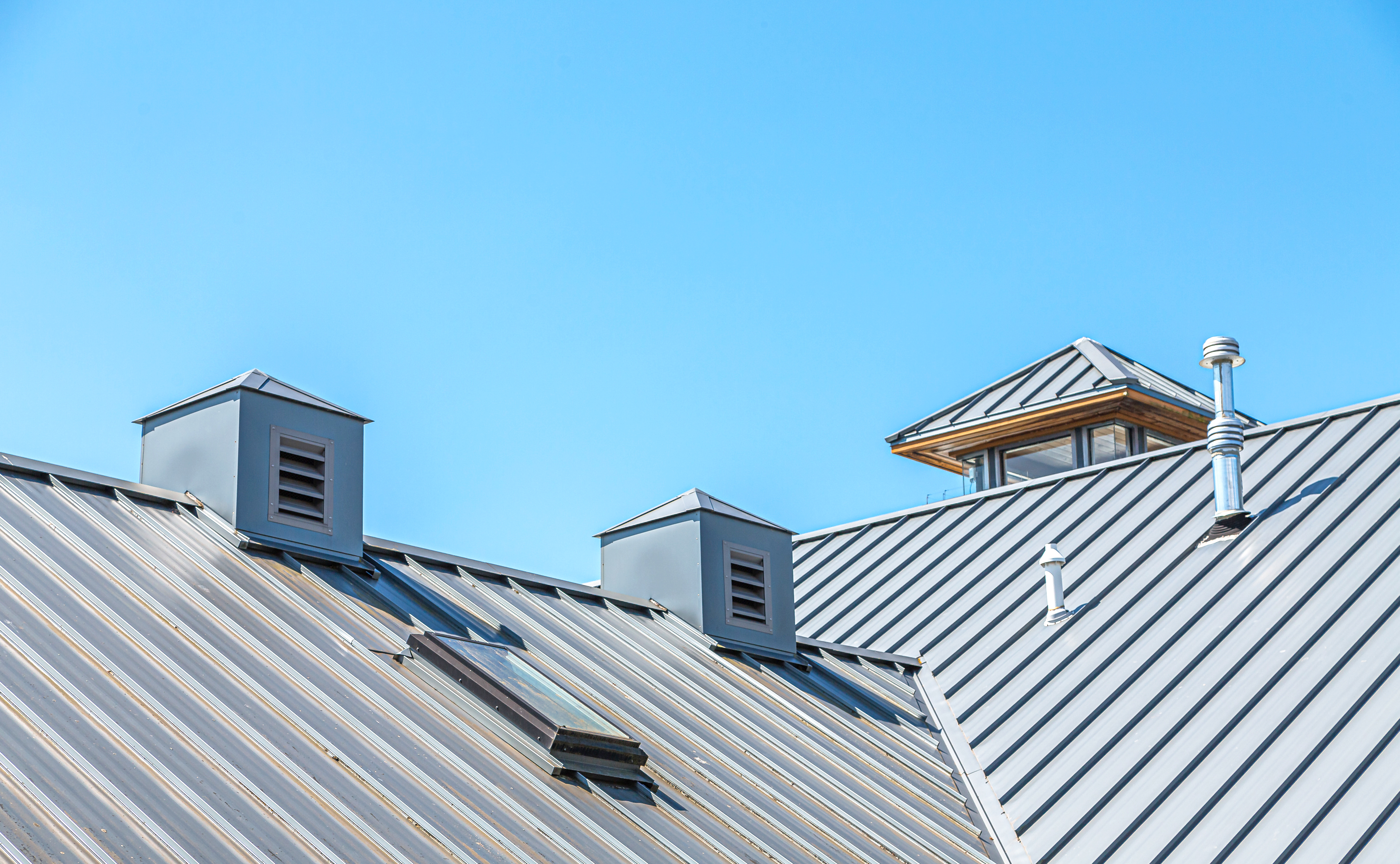 Standing seam metal roof and skylight window installed on a house
