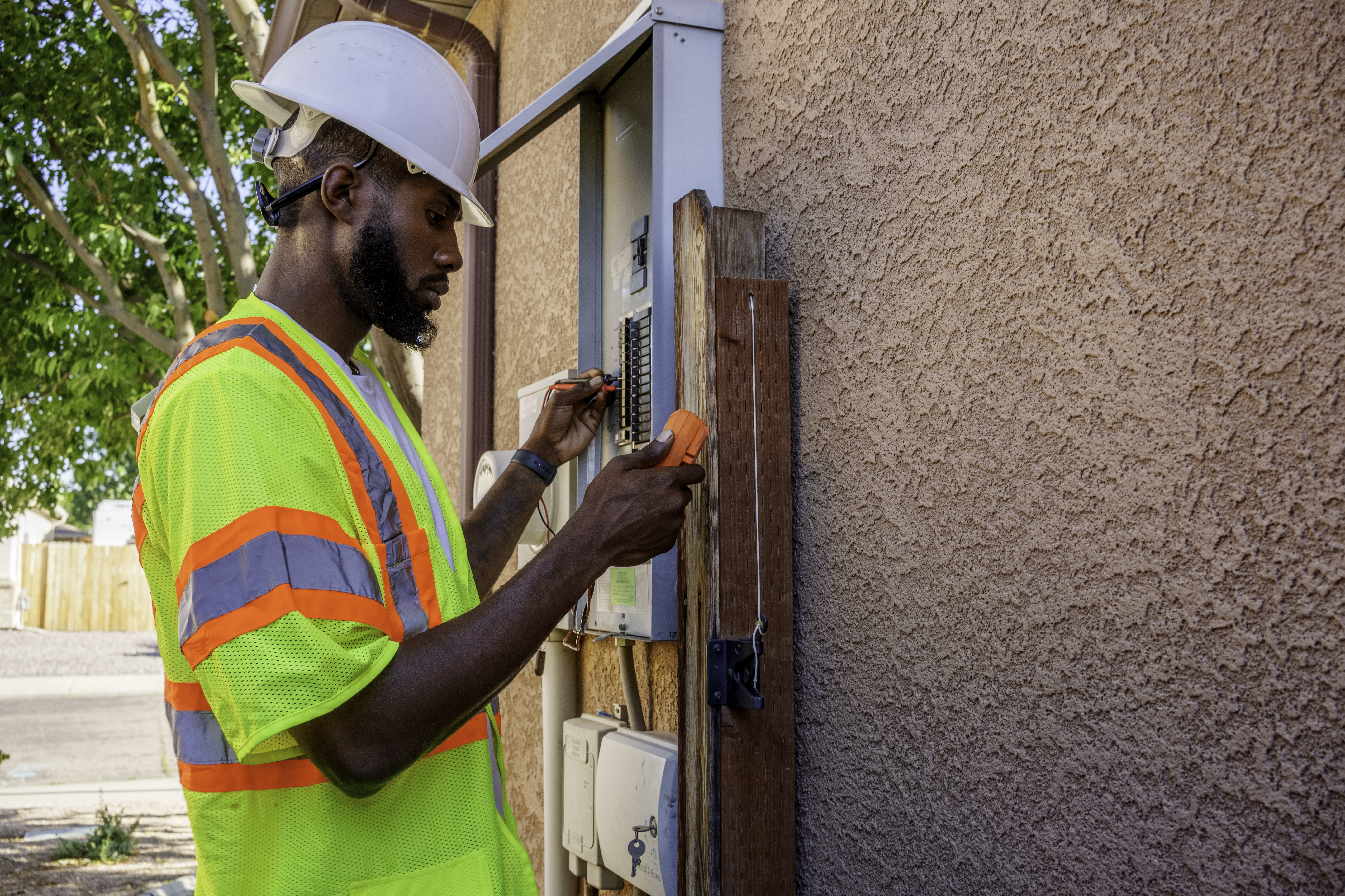 Worker checking outdoor electrical panel 