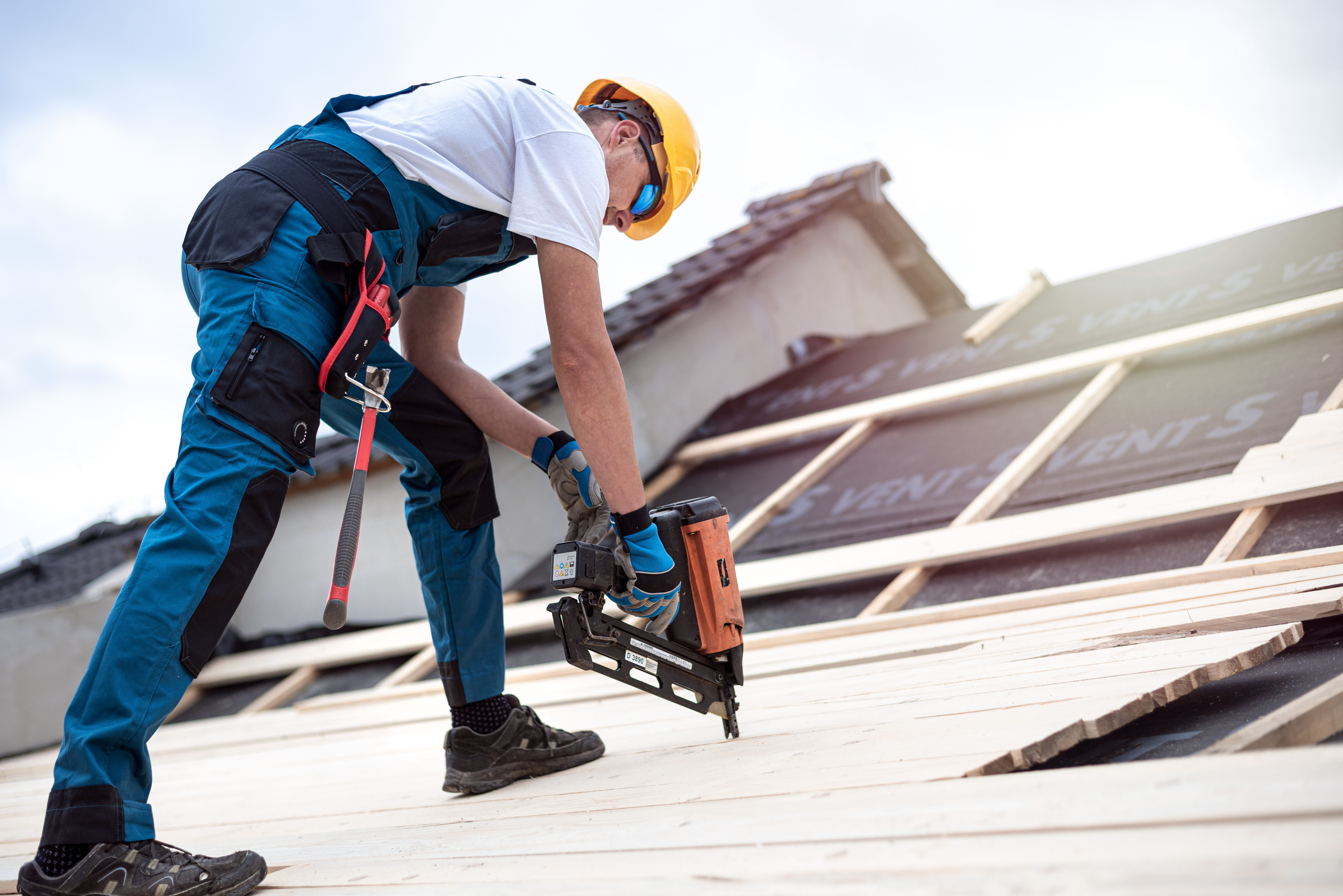 man repairing roof