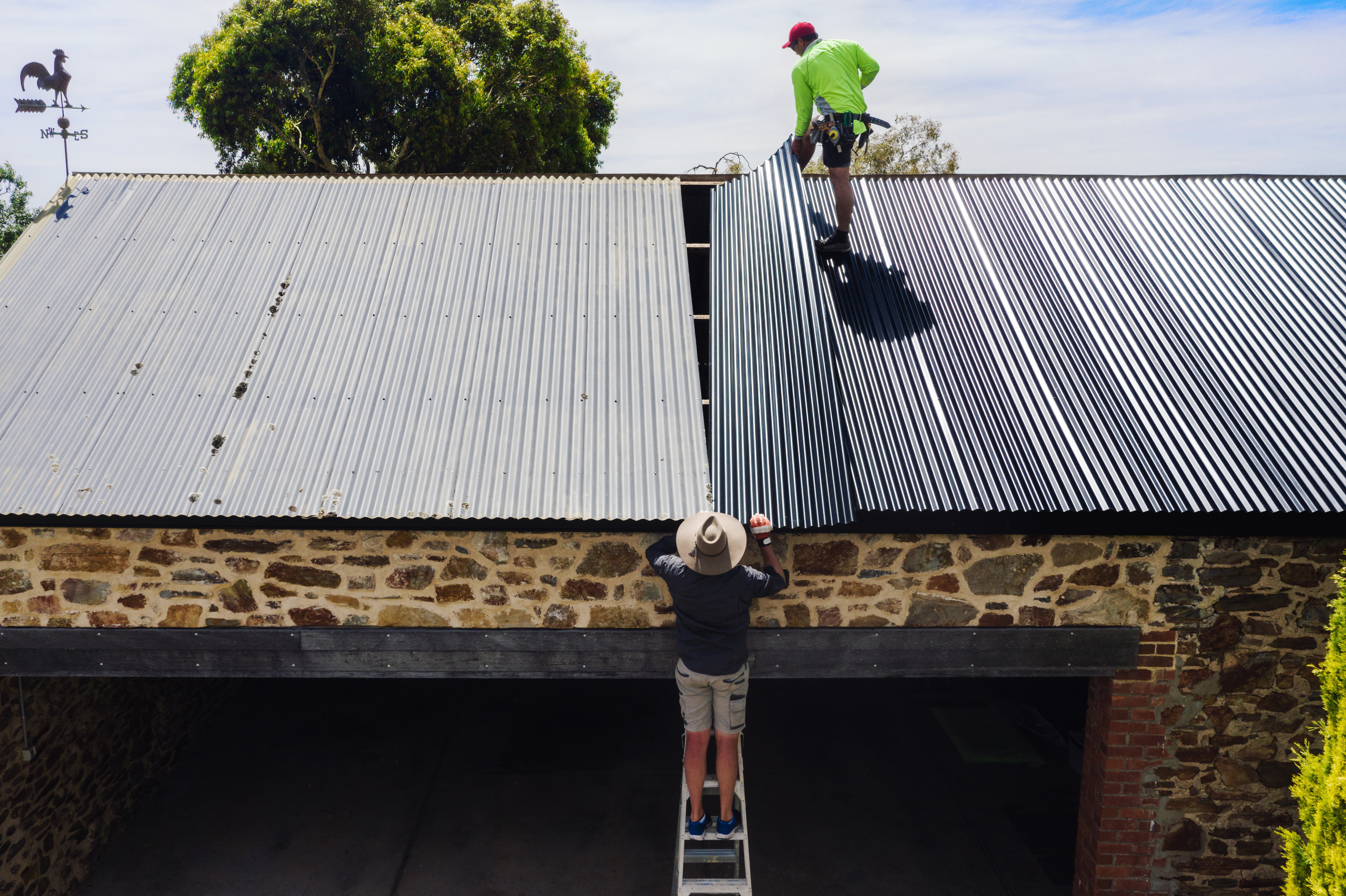 man installing metal roof