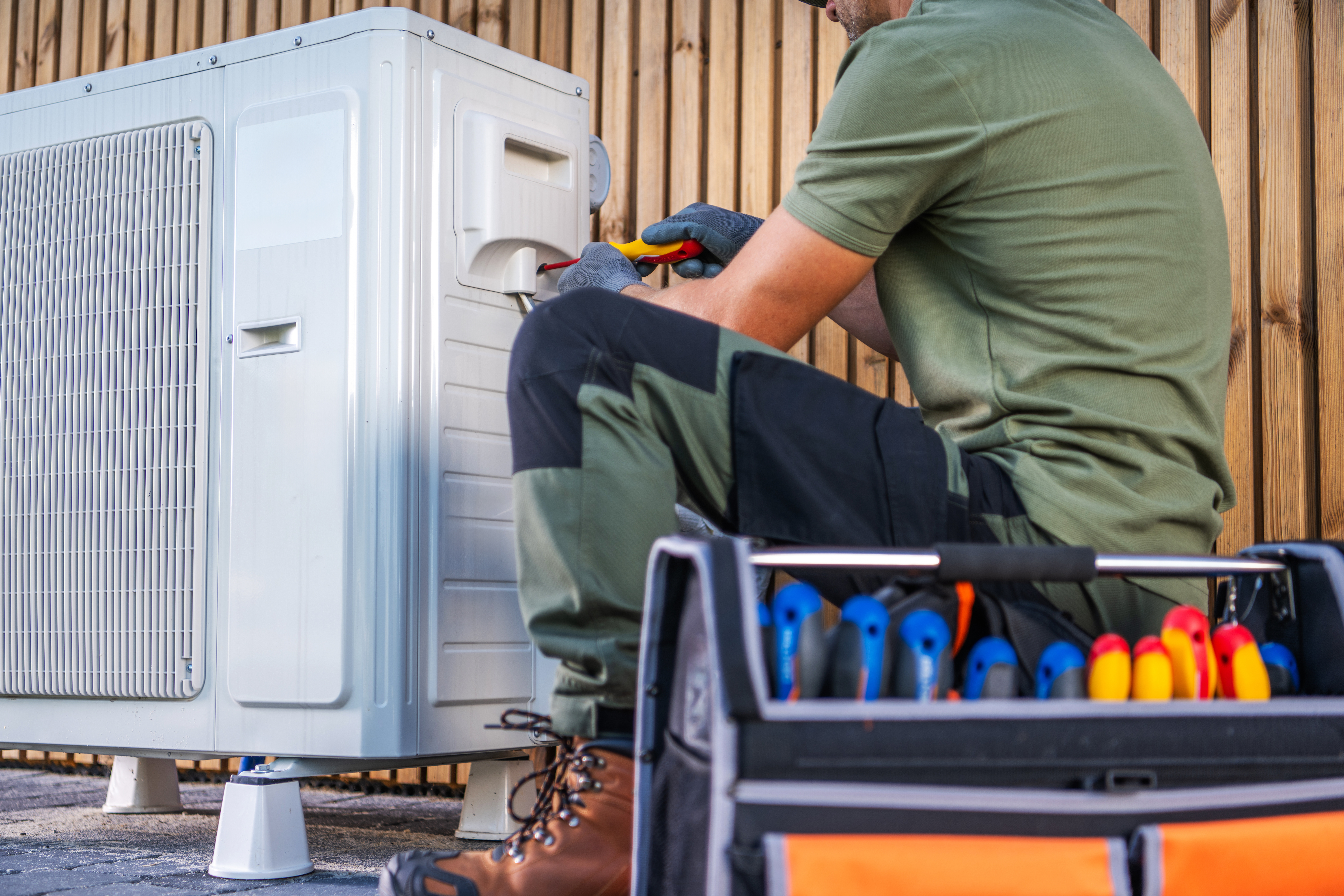 technician doing maintenance on ac unit