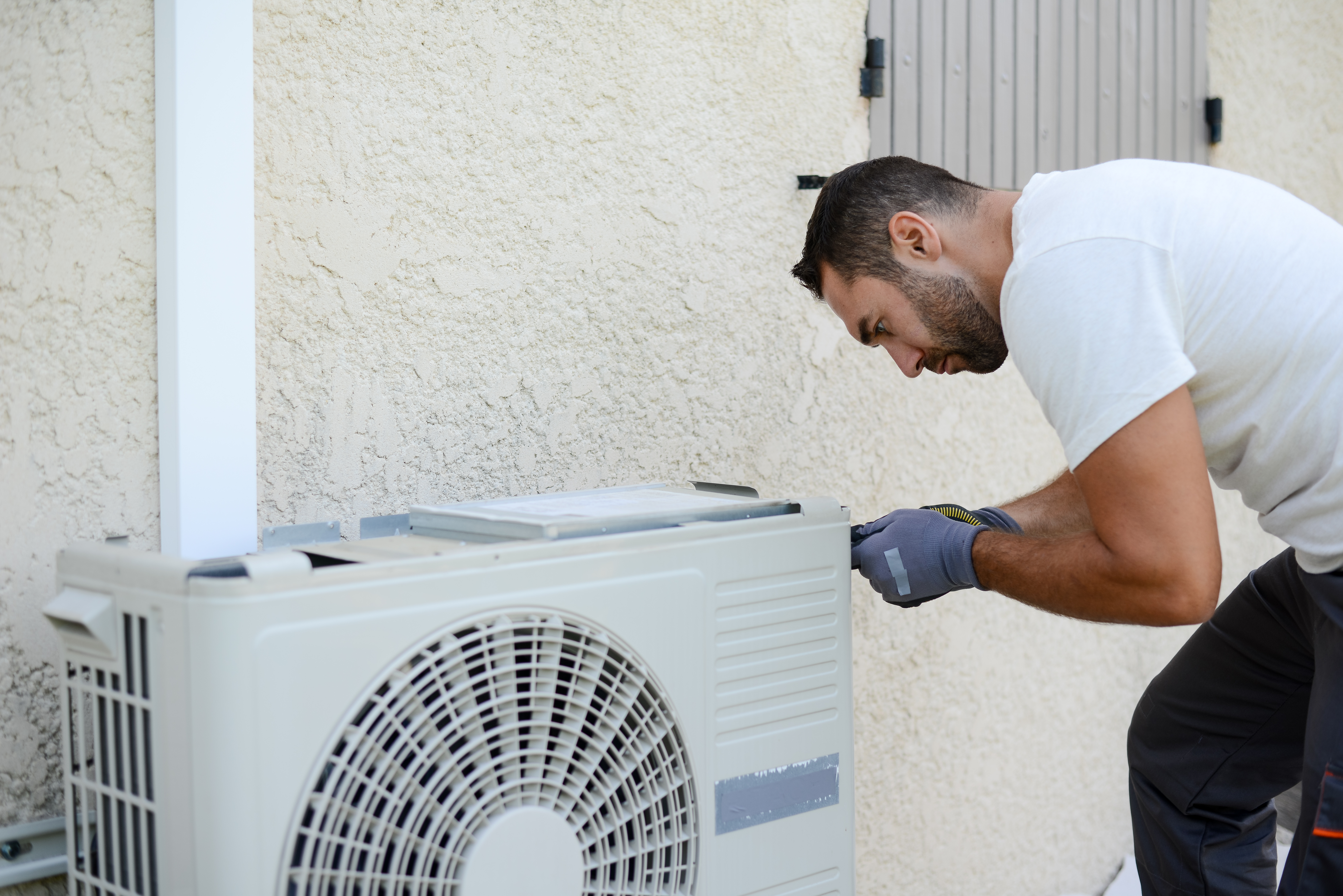 electrician installing ac unit outside