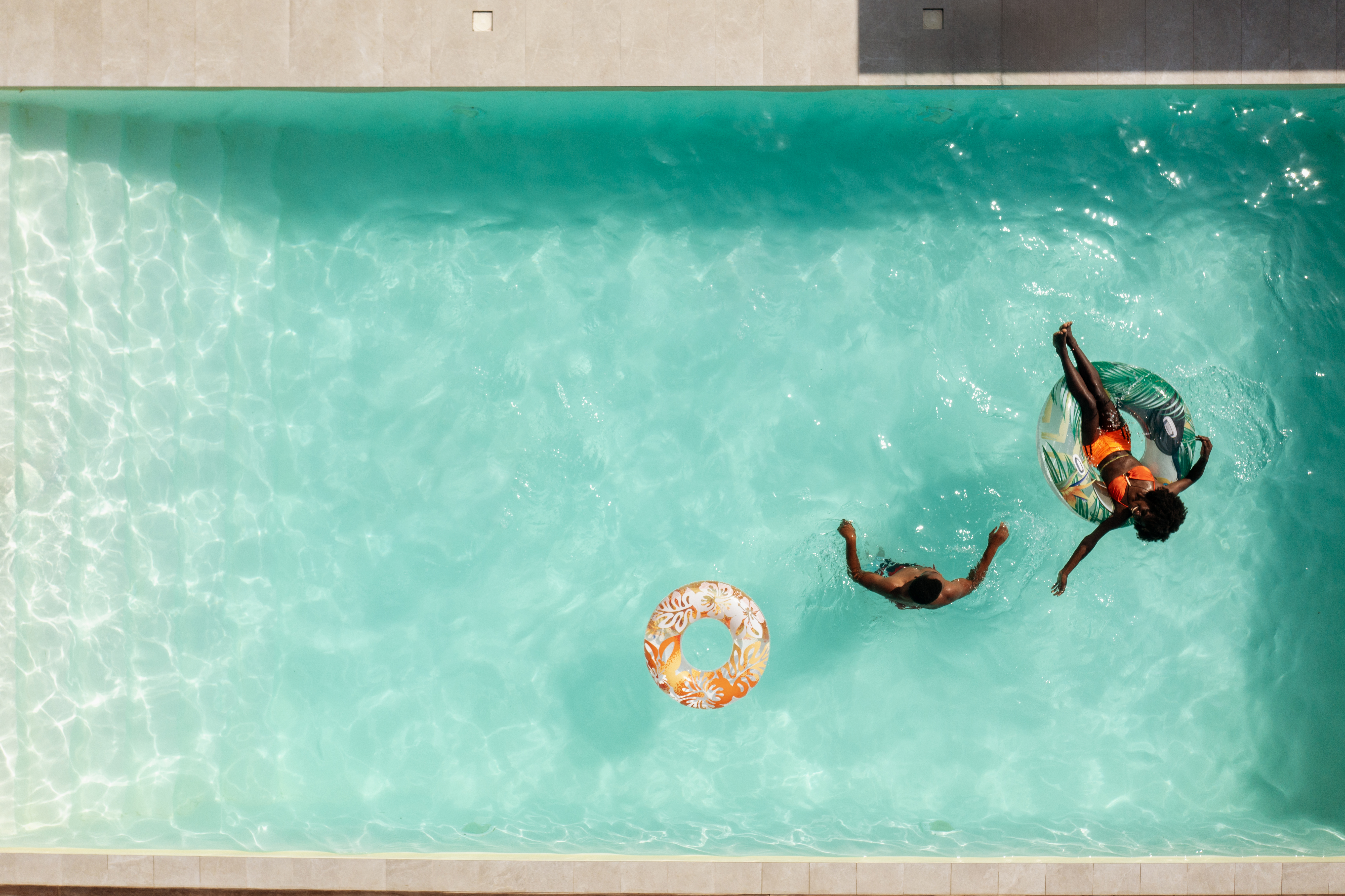 Couple relaxing in a swimming pool with a white liner