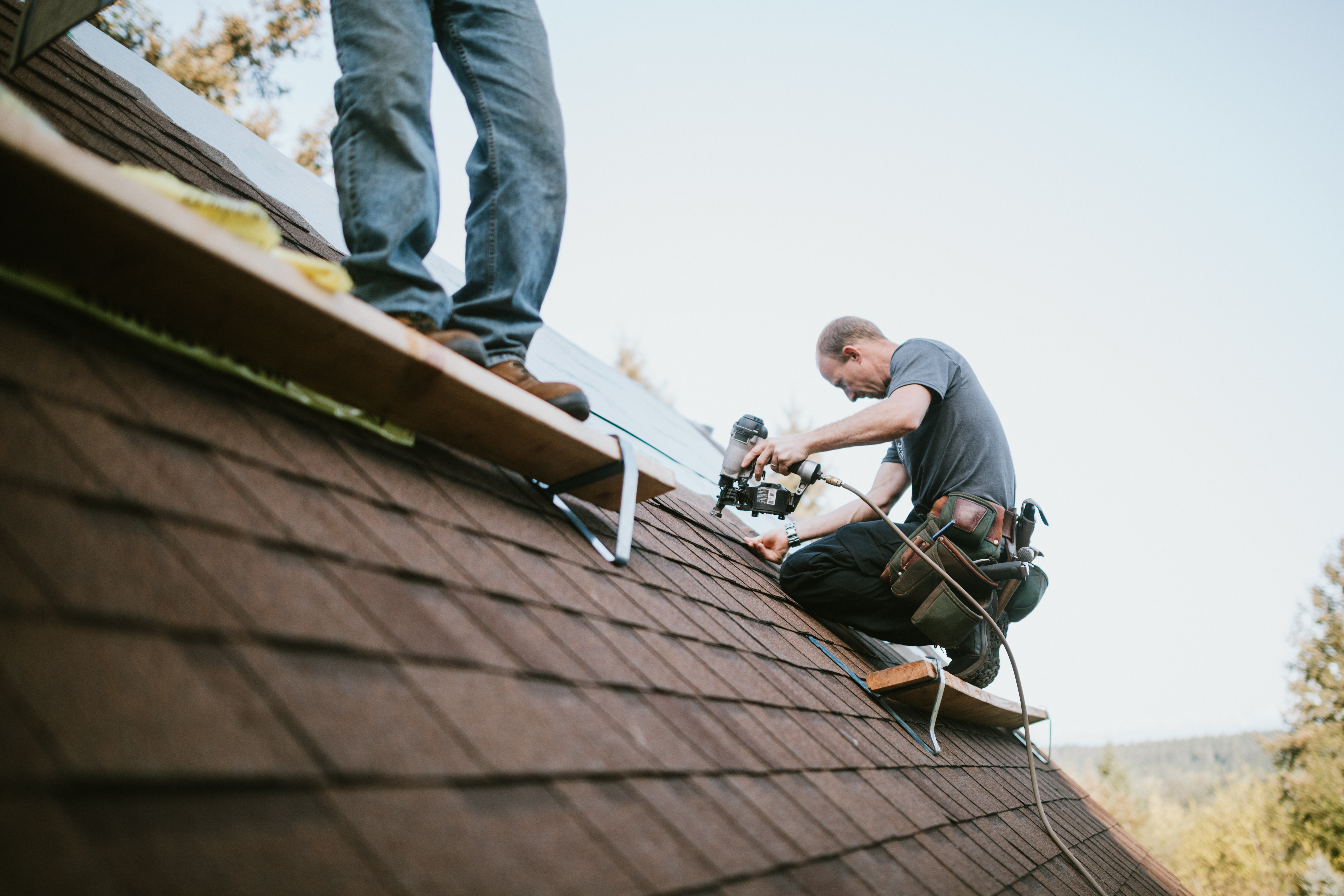 men installing new roof  
