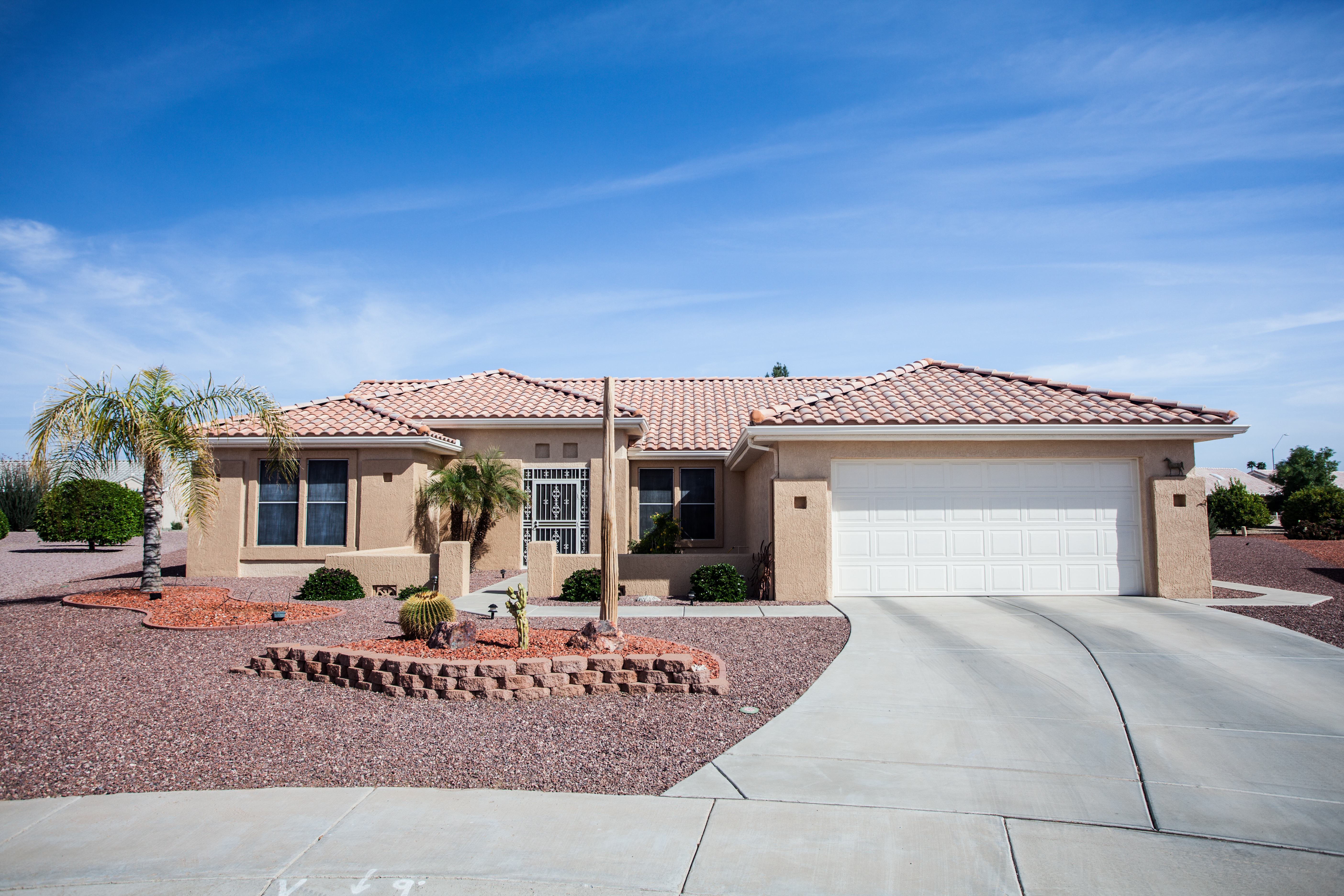 Arizona-style house with clay tile roof and xeriscape