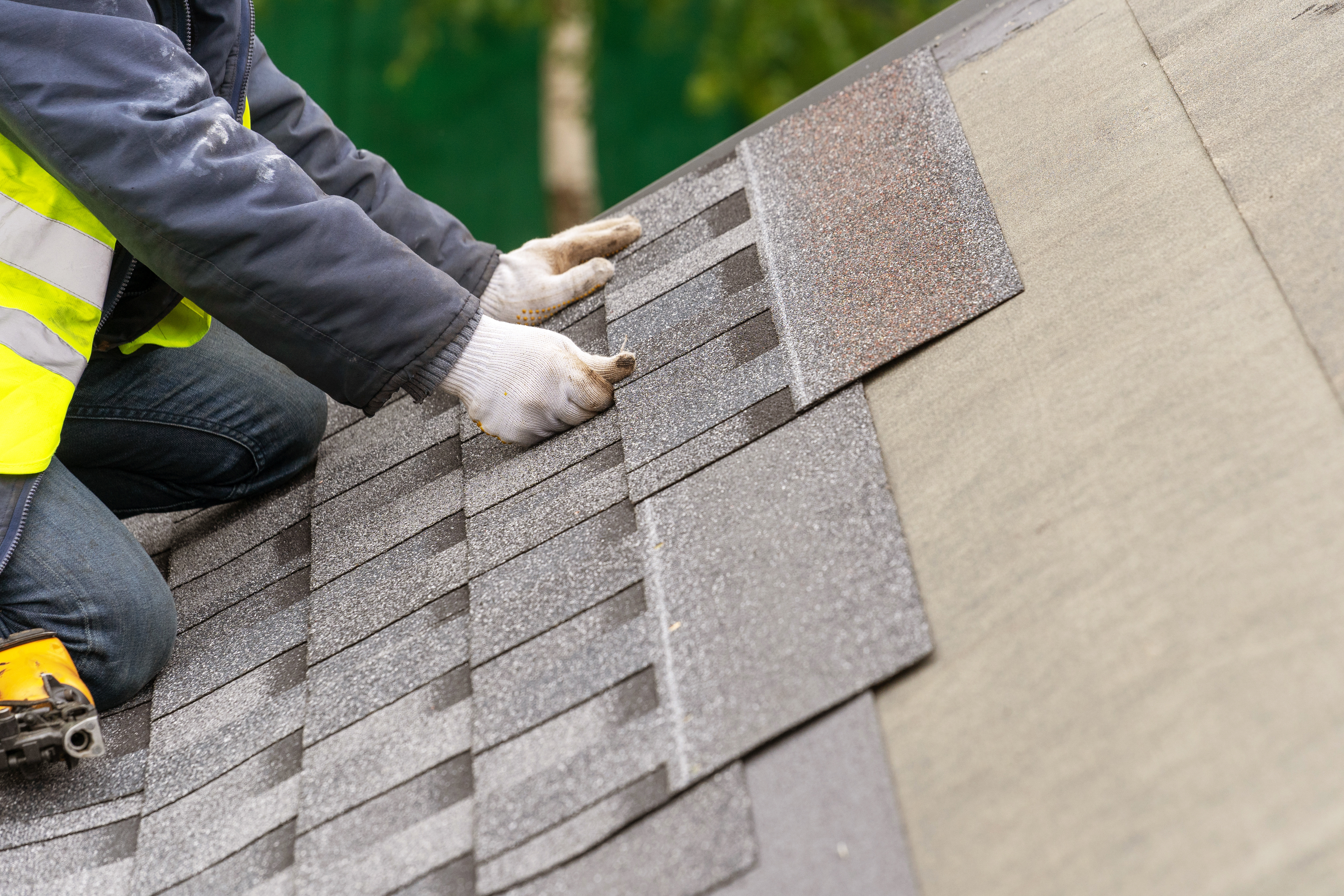 workman installing tile on roof  