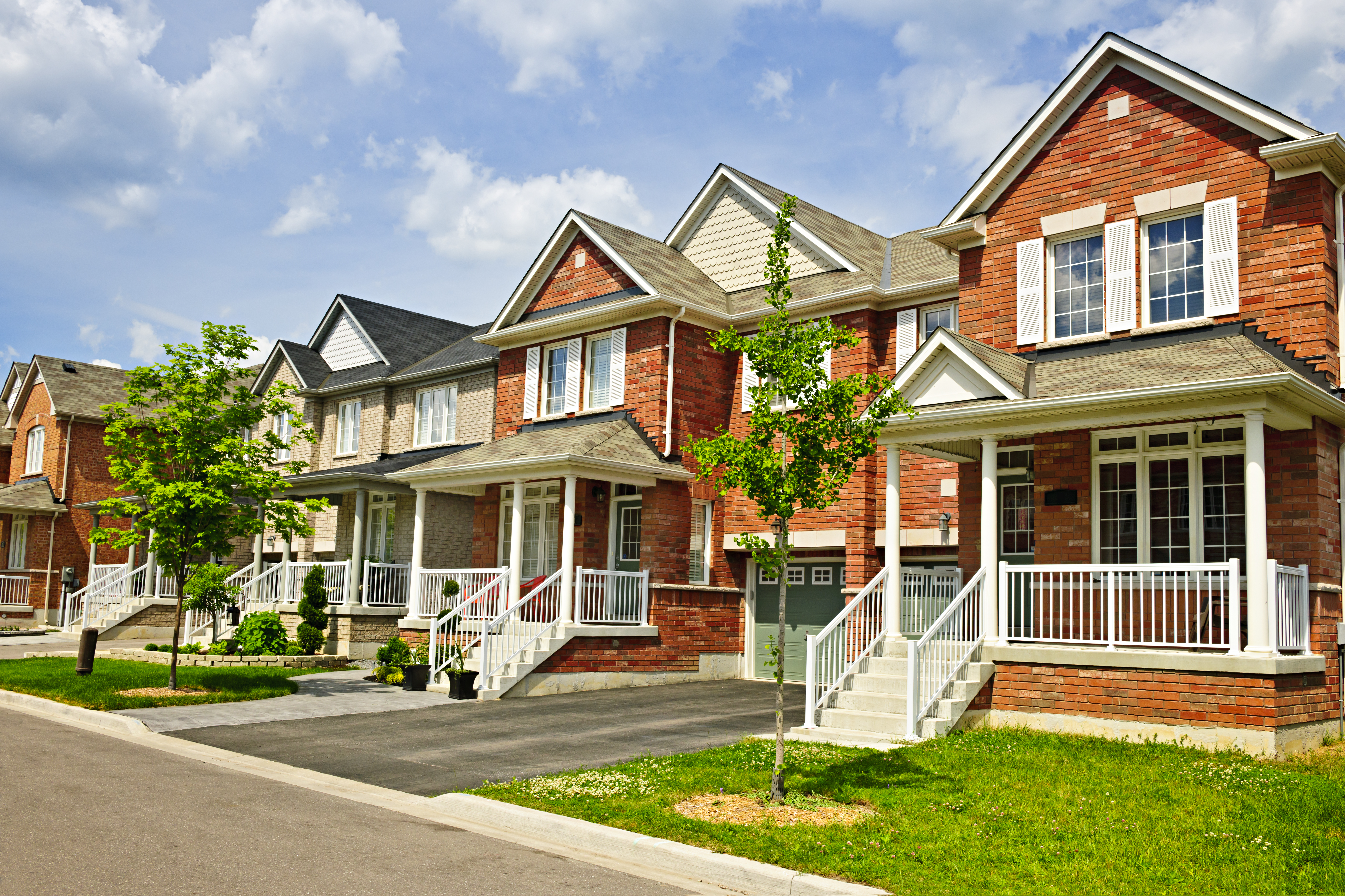 Street with a row of red brick houses  