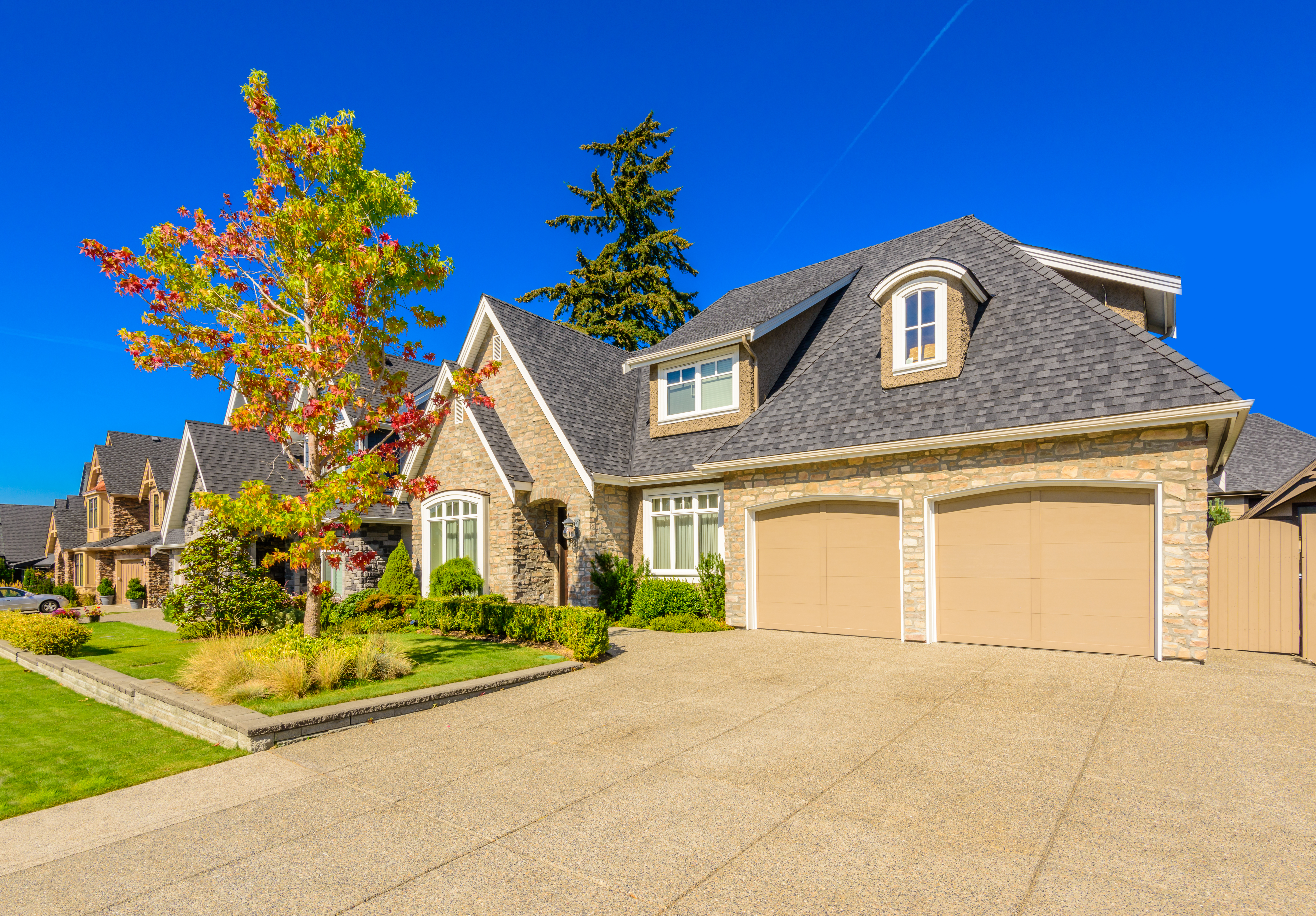 Houses with stone siding and asphalt shingle roof  