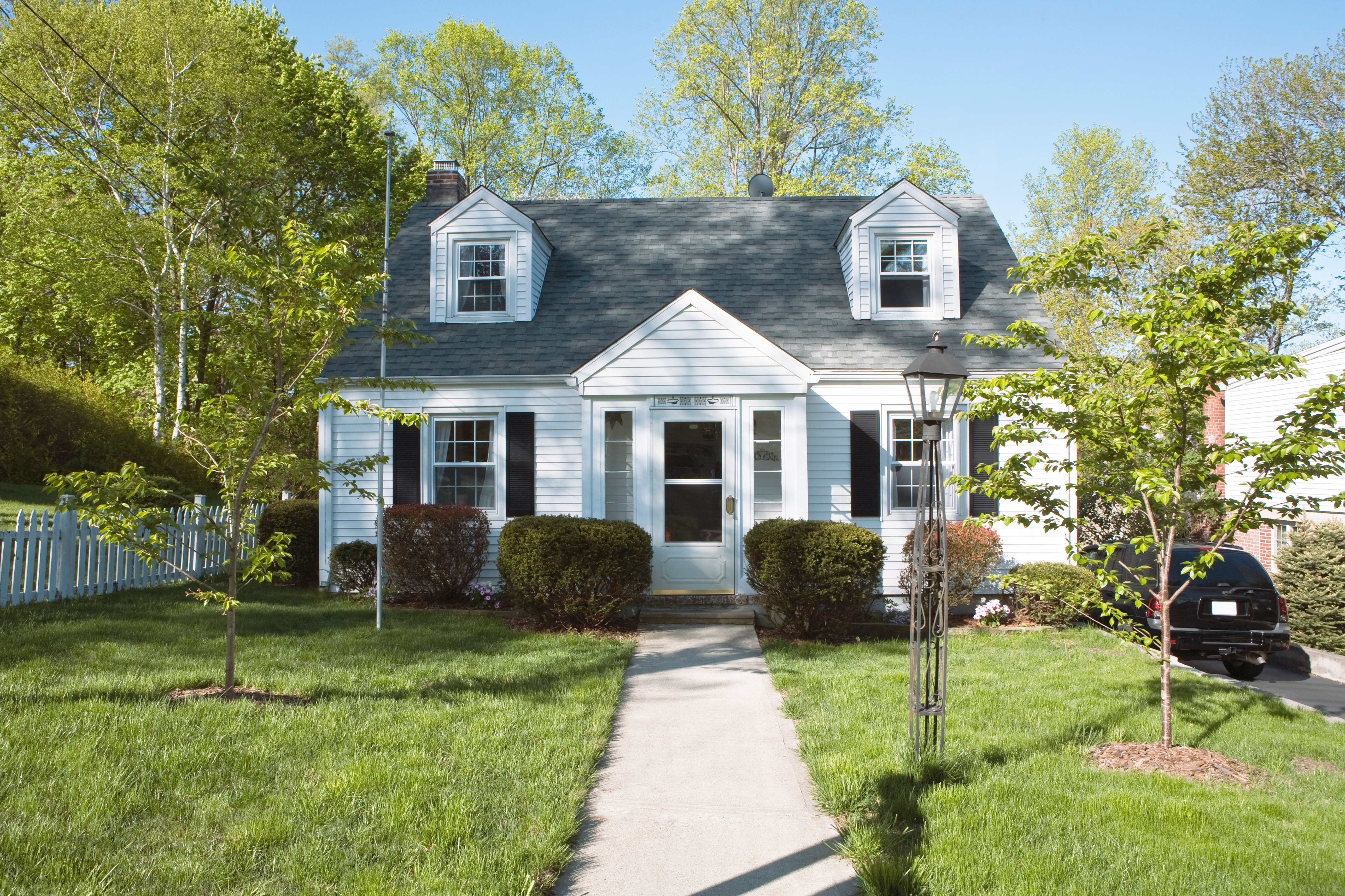 Single-family home with asphalt roof shingles and white siding   
