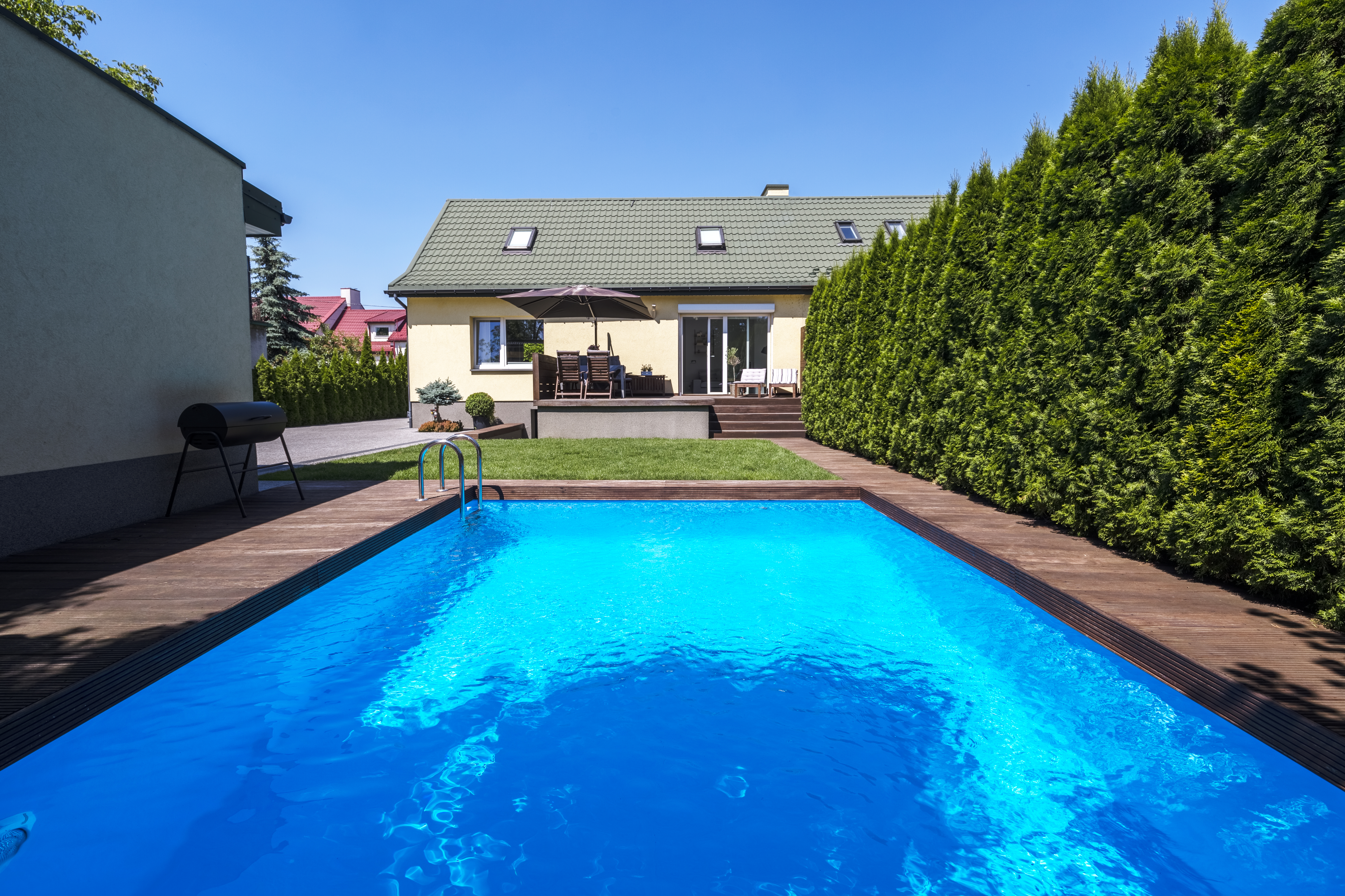 A pool in the backyard of a house 