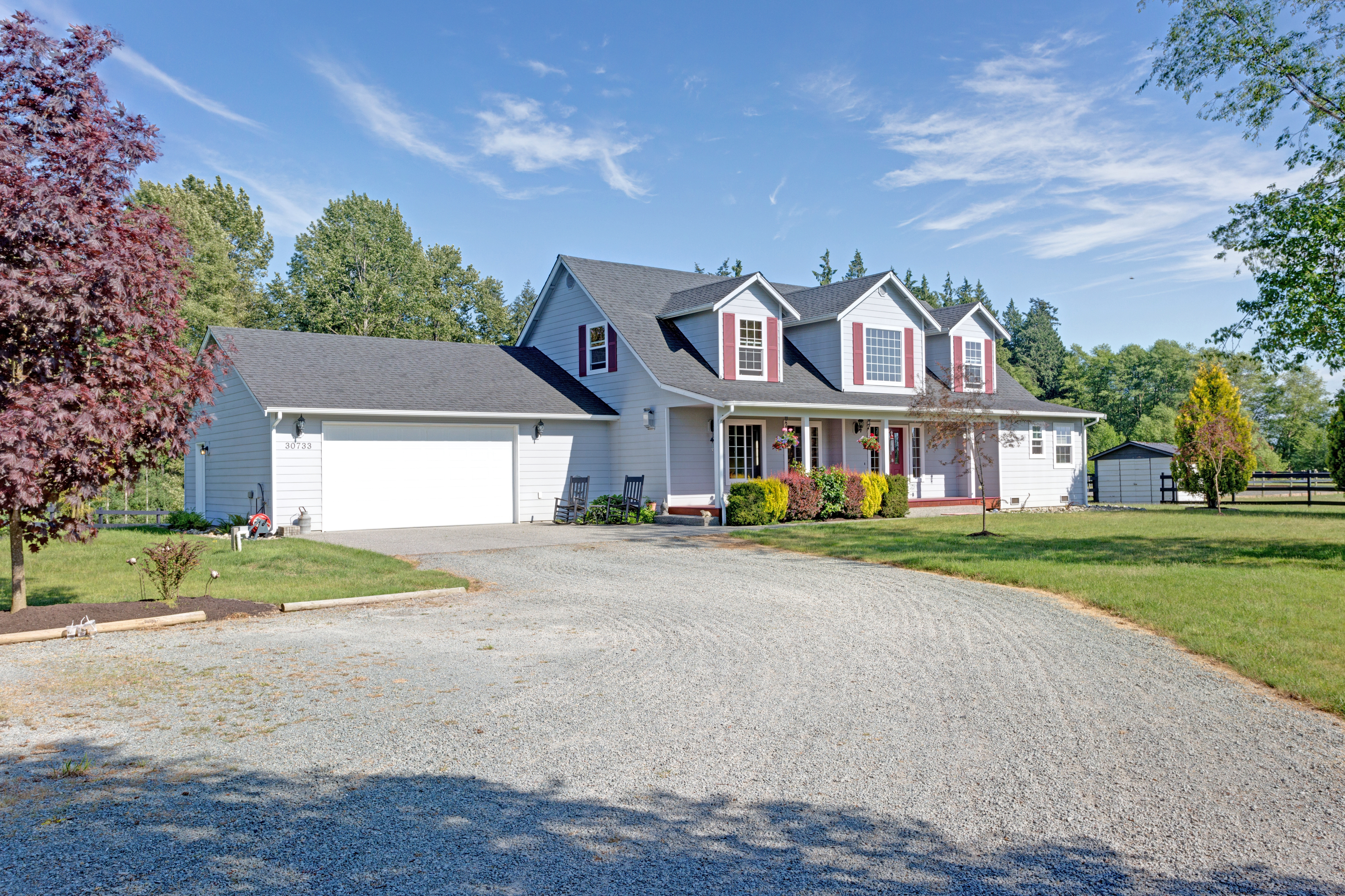 The exterior of a house with red shutters