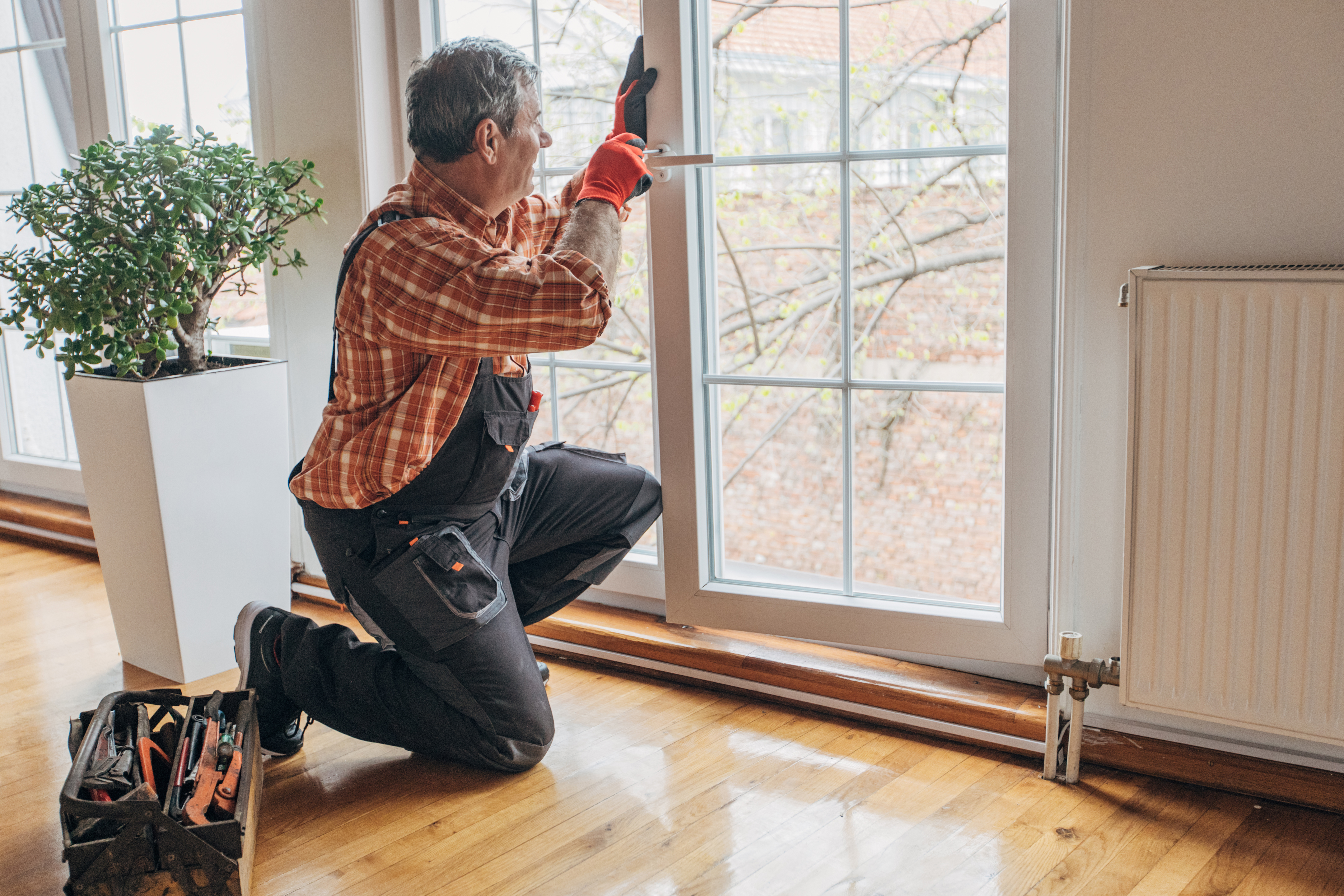 A professional installing a new window