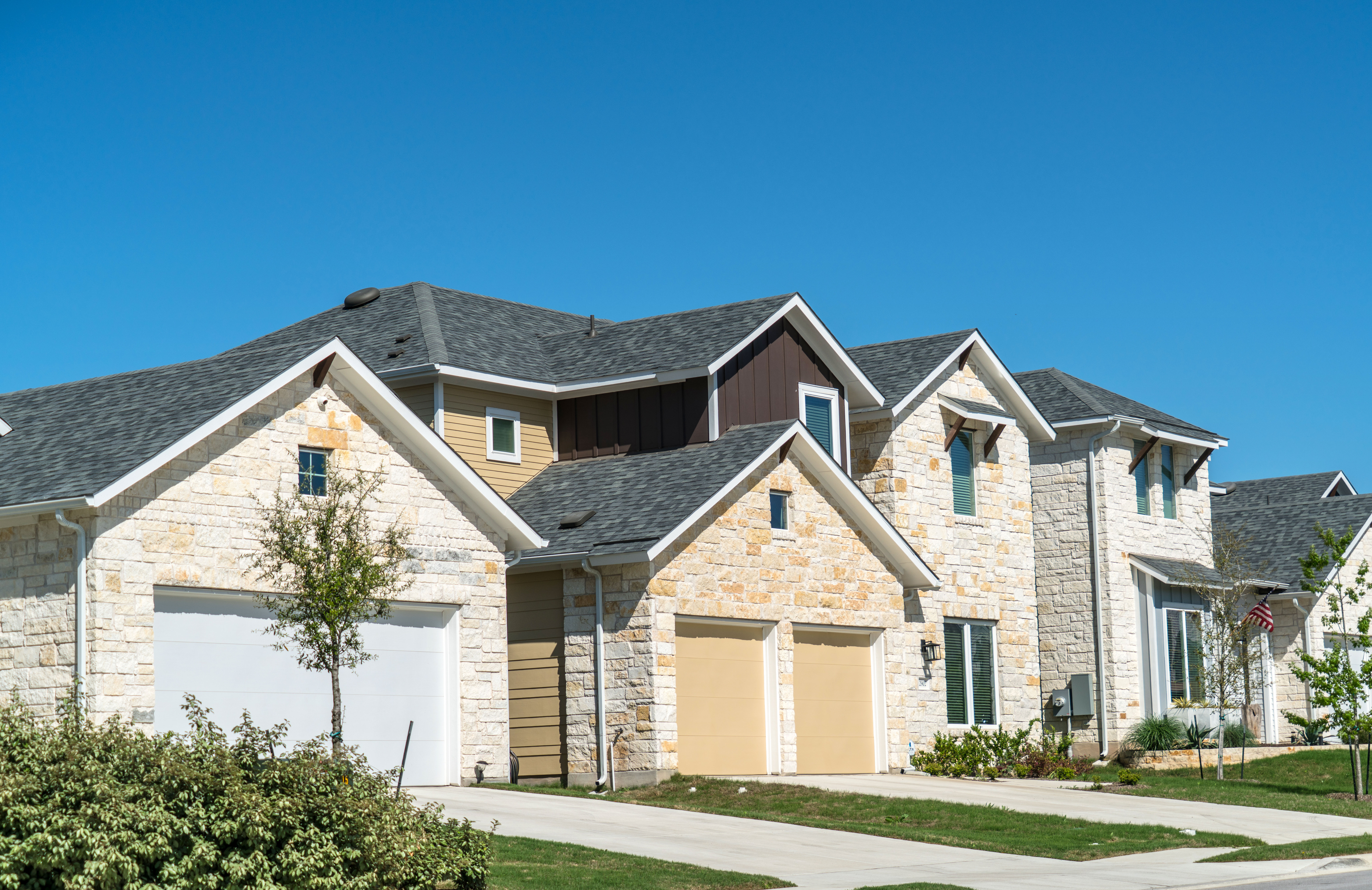 New houses with asphalt shingle roofs in Austin