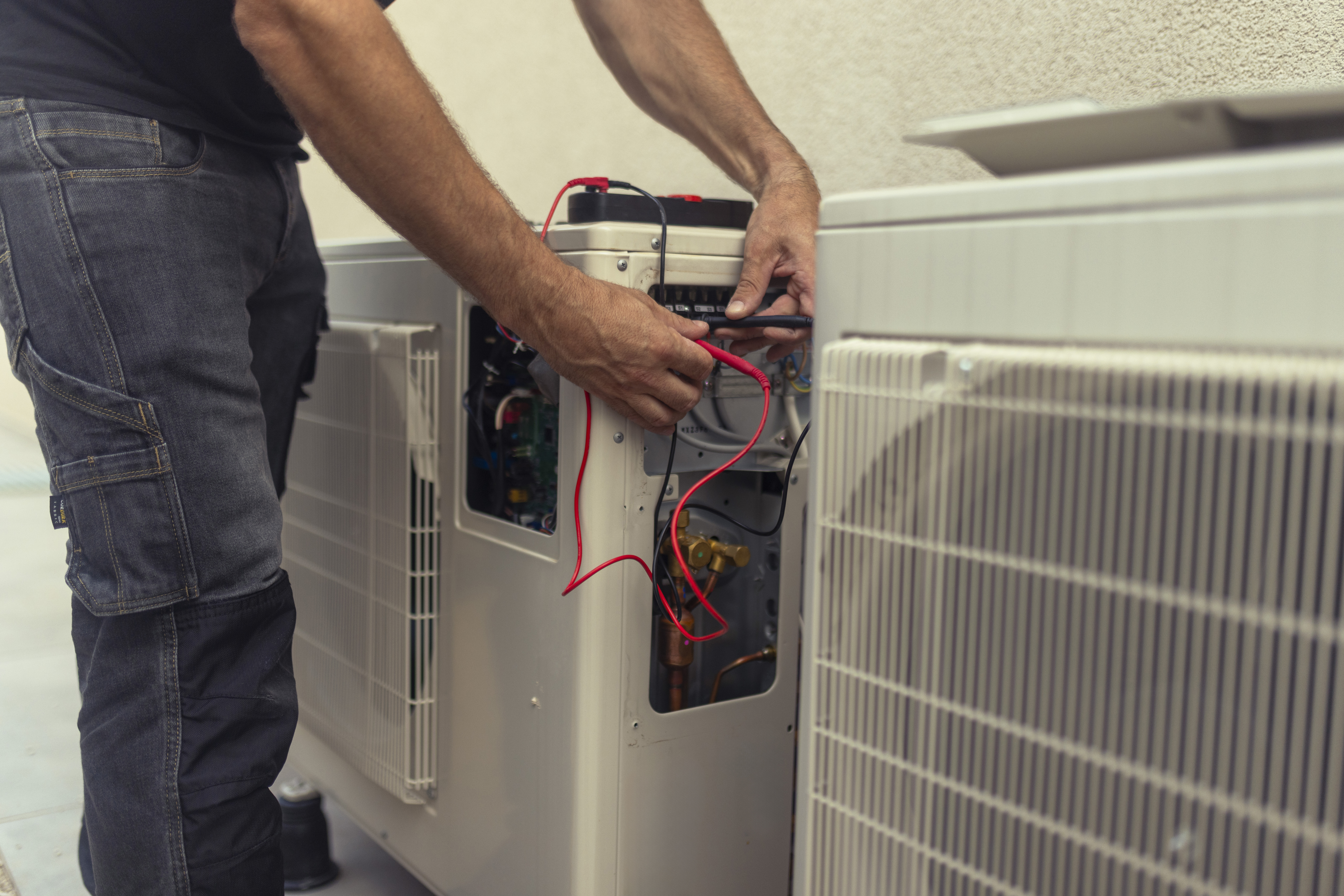 Electrician installing a heat pump