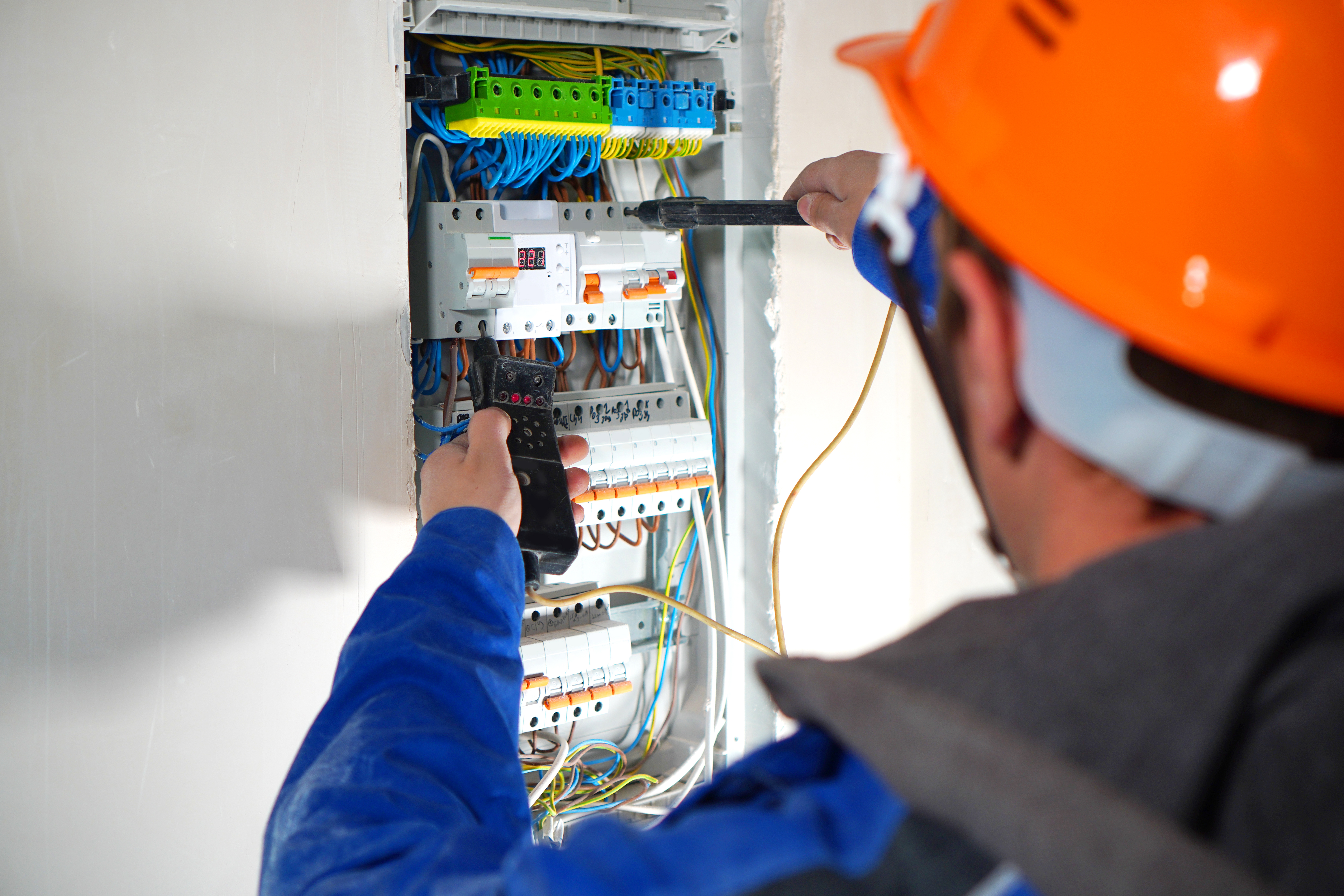 electrician testing switchboard  