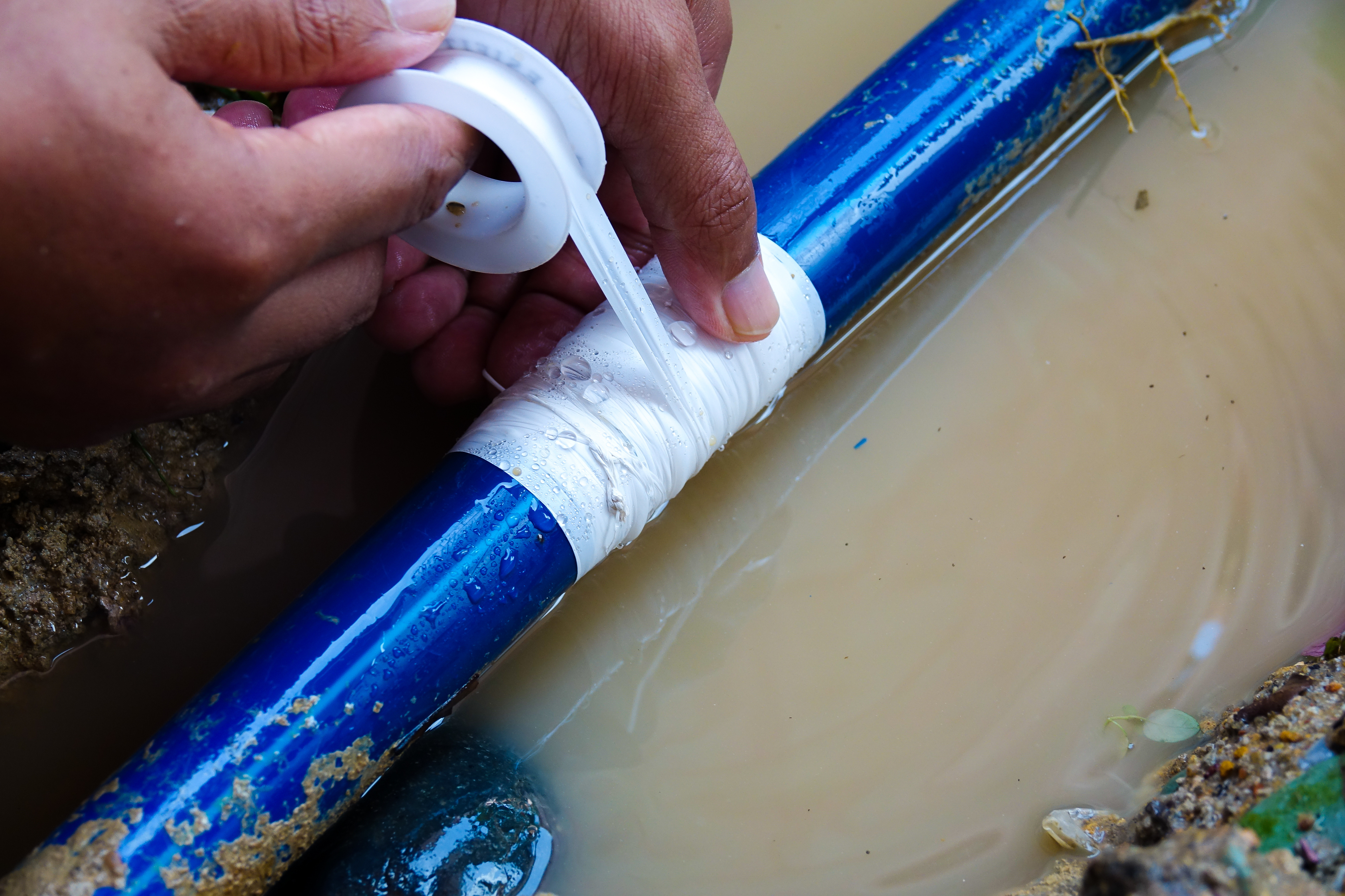 water pipe break being repaired with tape