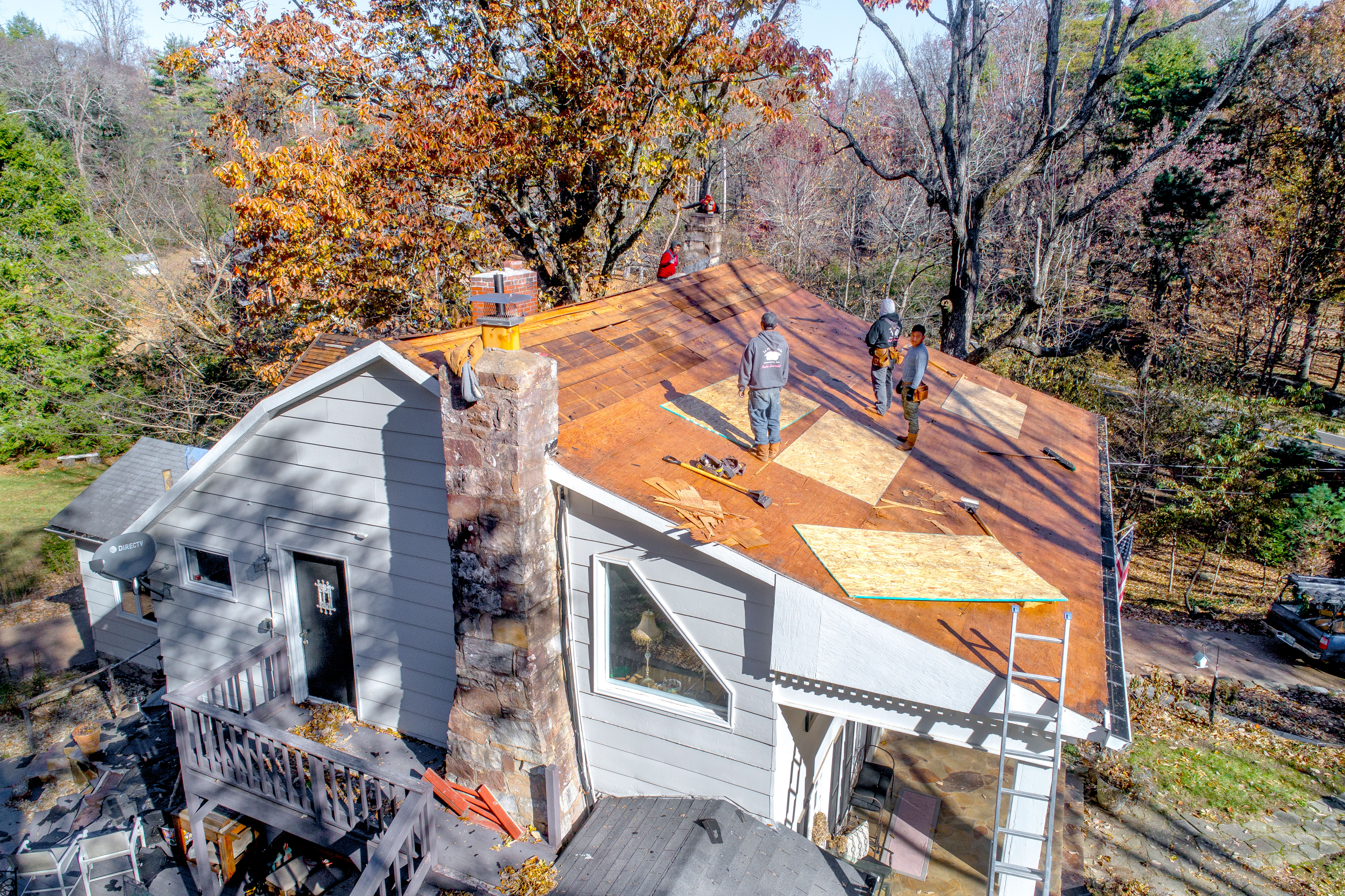 Workers replacing the roof on a single-family home
