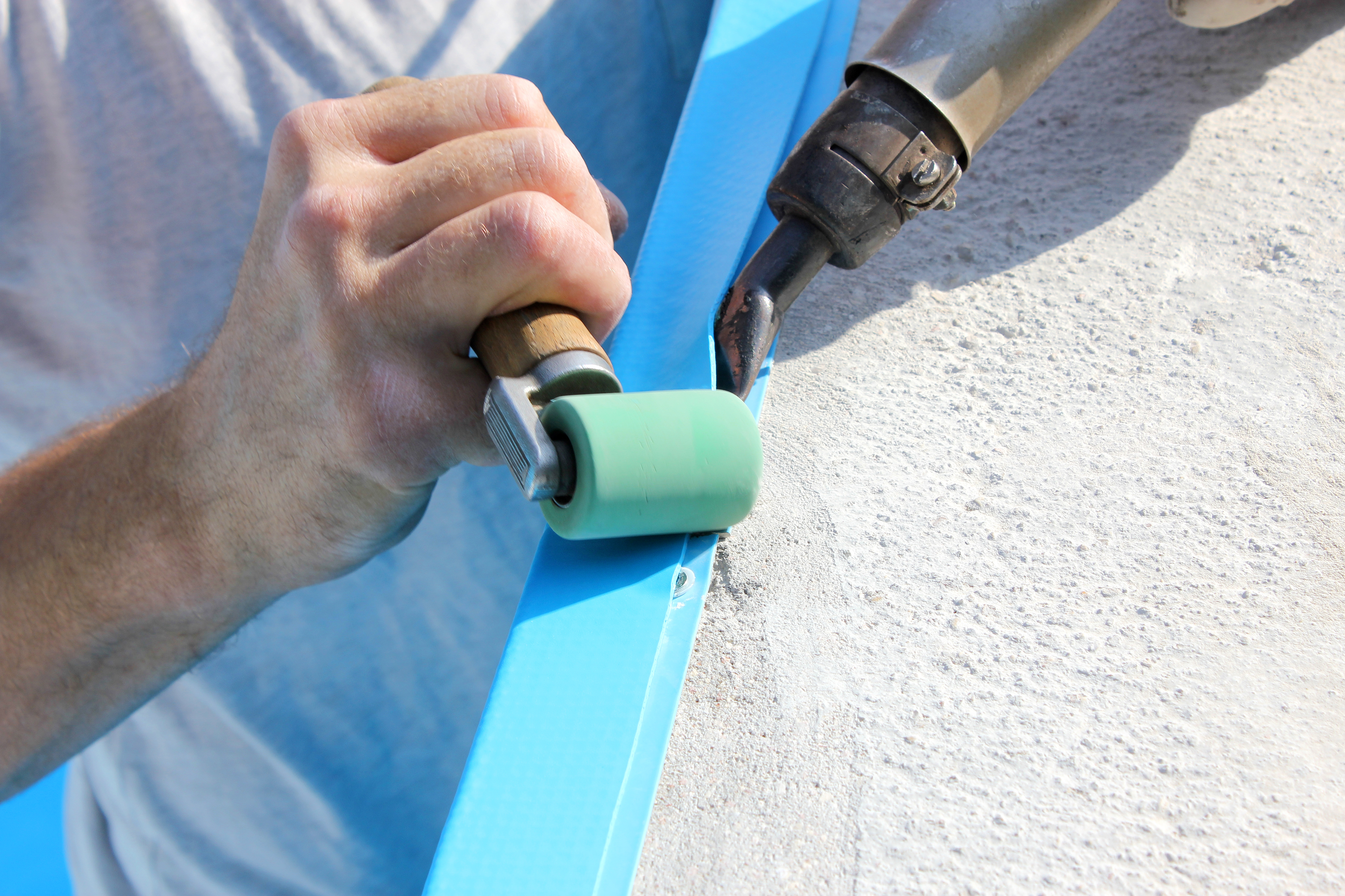 Close-up of a professional installing a new pool liner