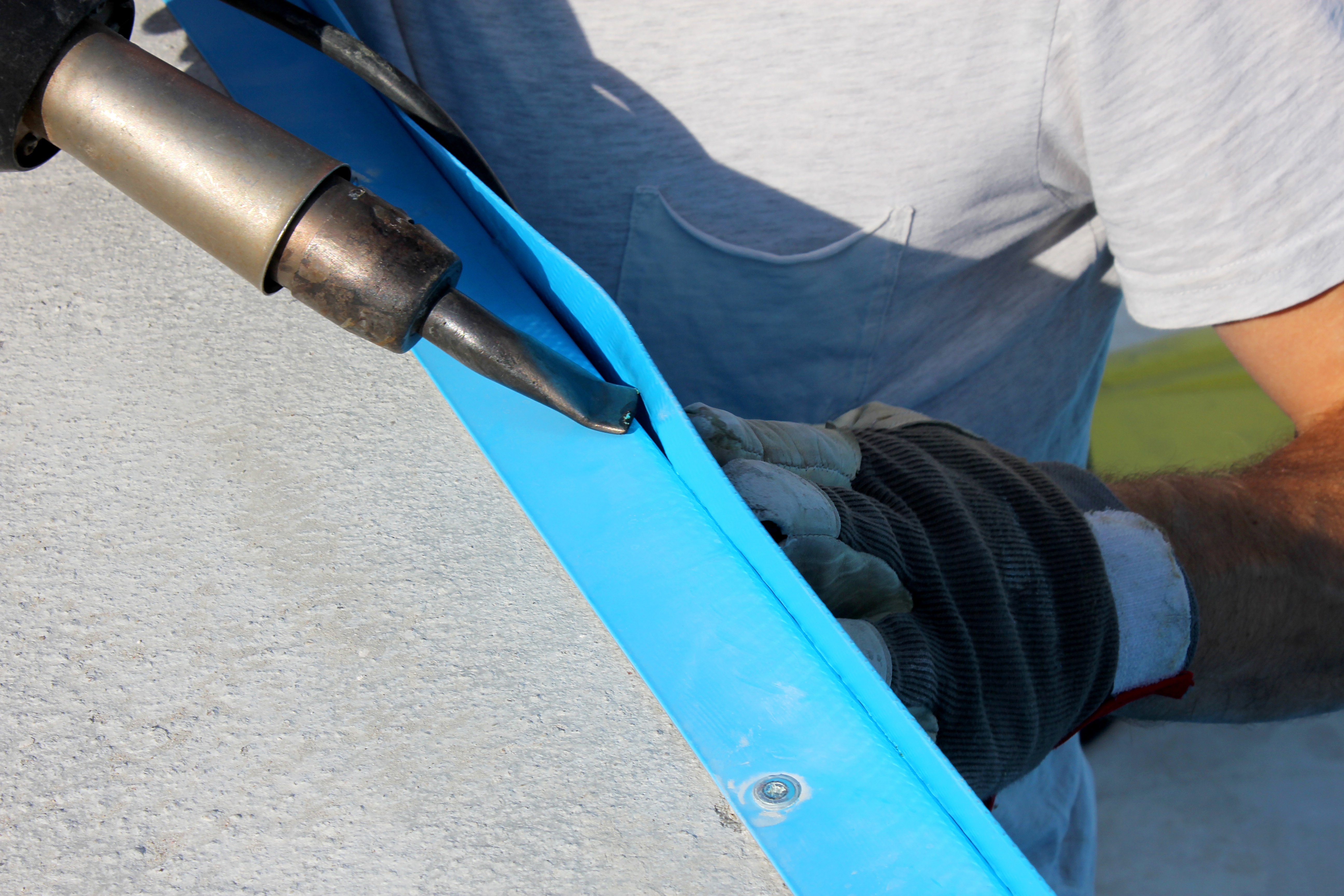 Close-up of a professional installing a pool liner