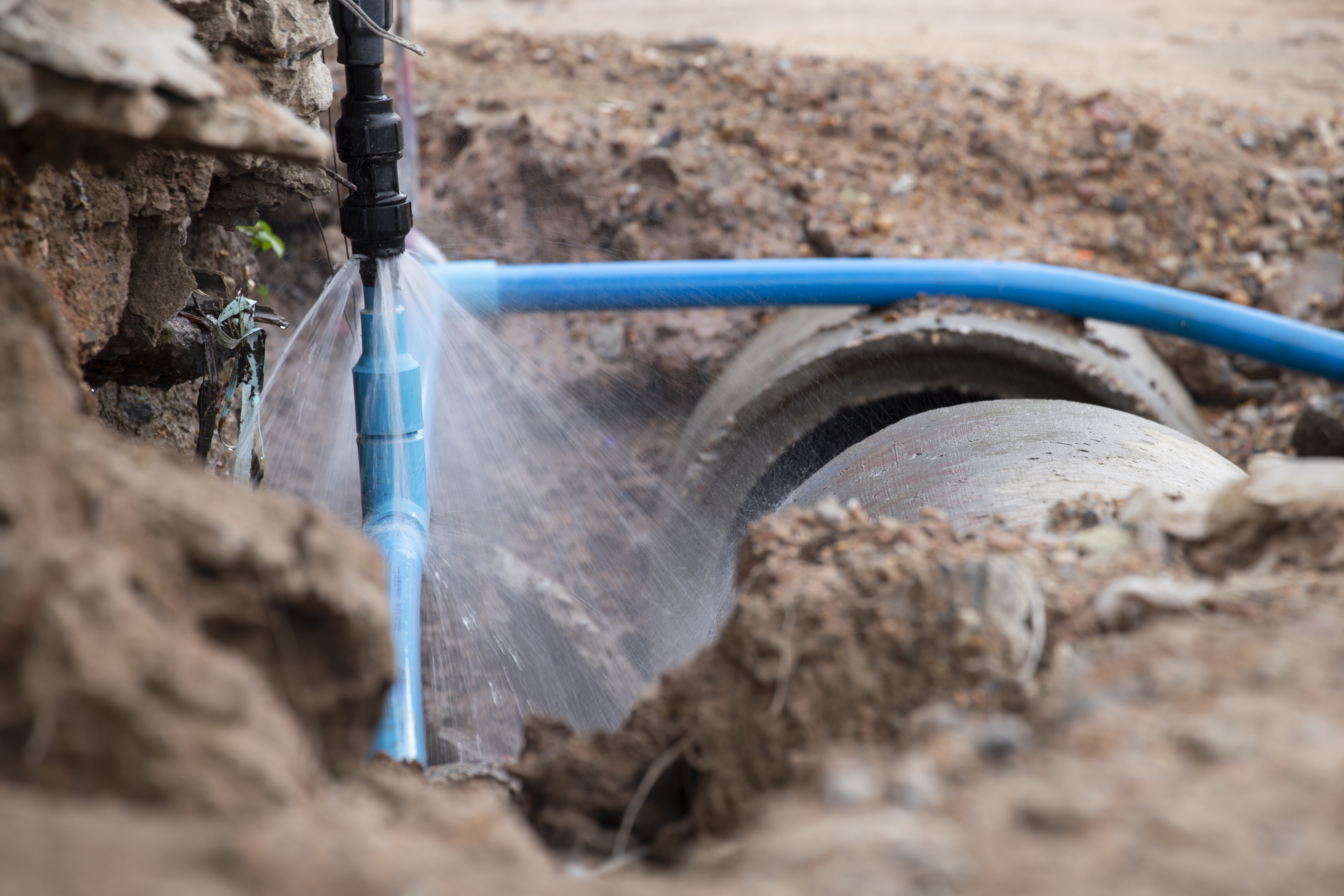 A broken water pipe is spraying water
