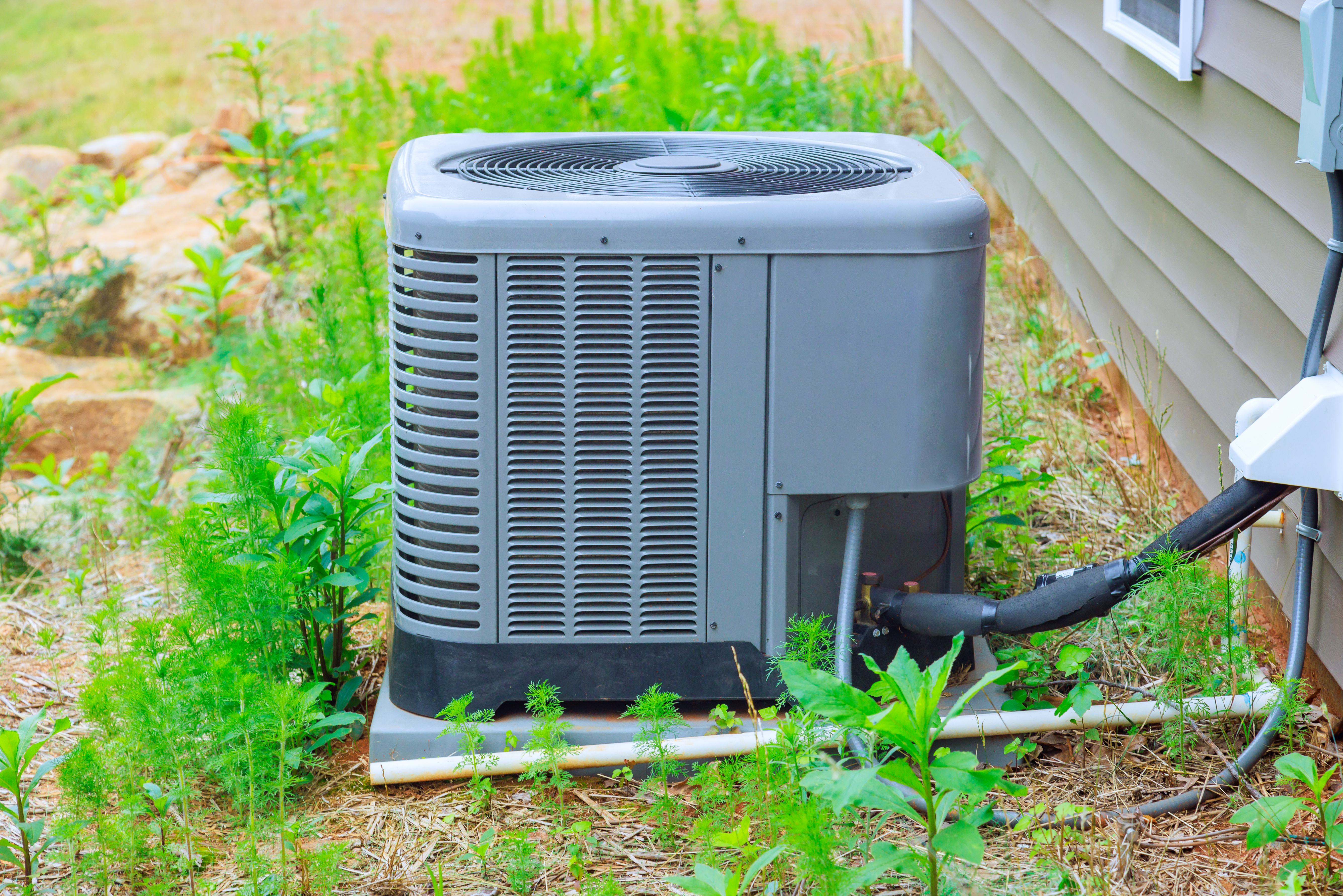 New air conditioner system unit sitting in the yard