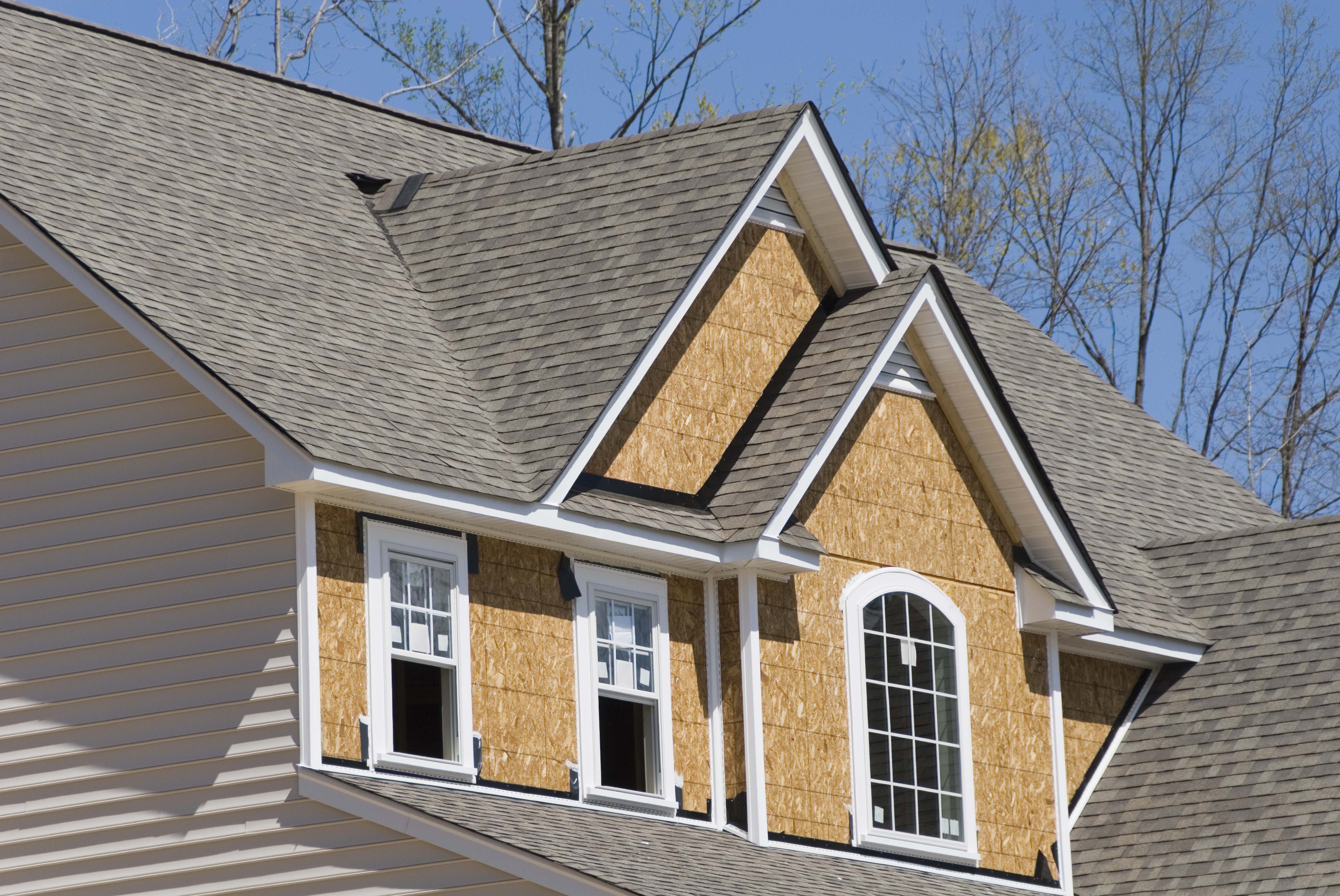 House with vinyl siding partially installed