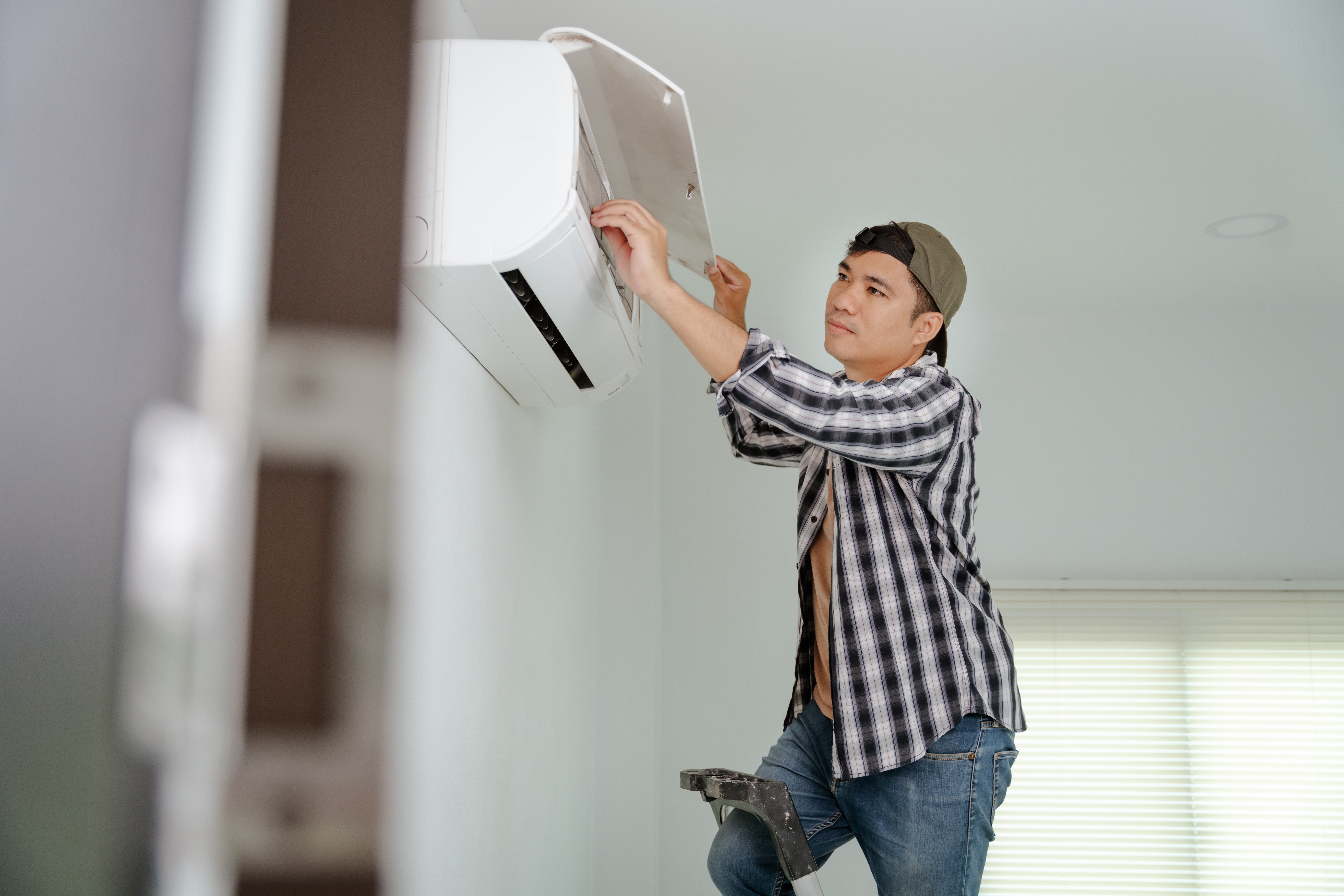 A person installing a ductless AC 