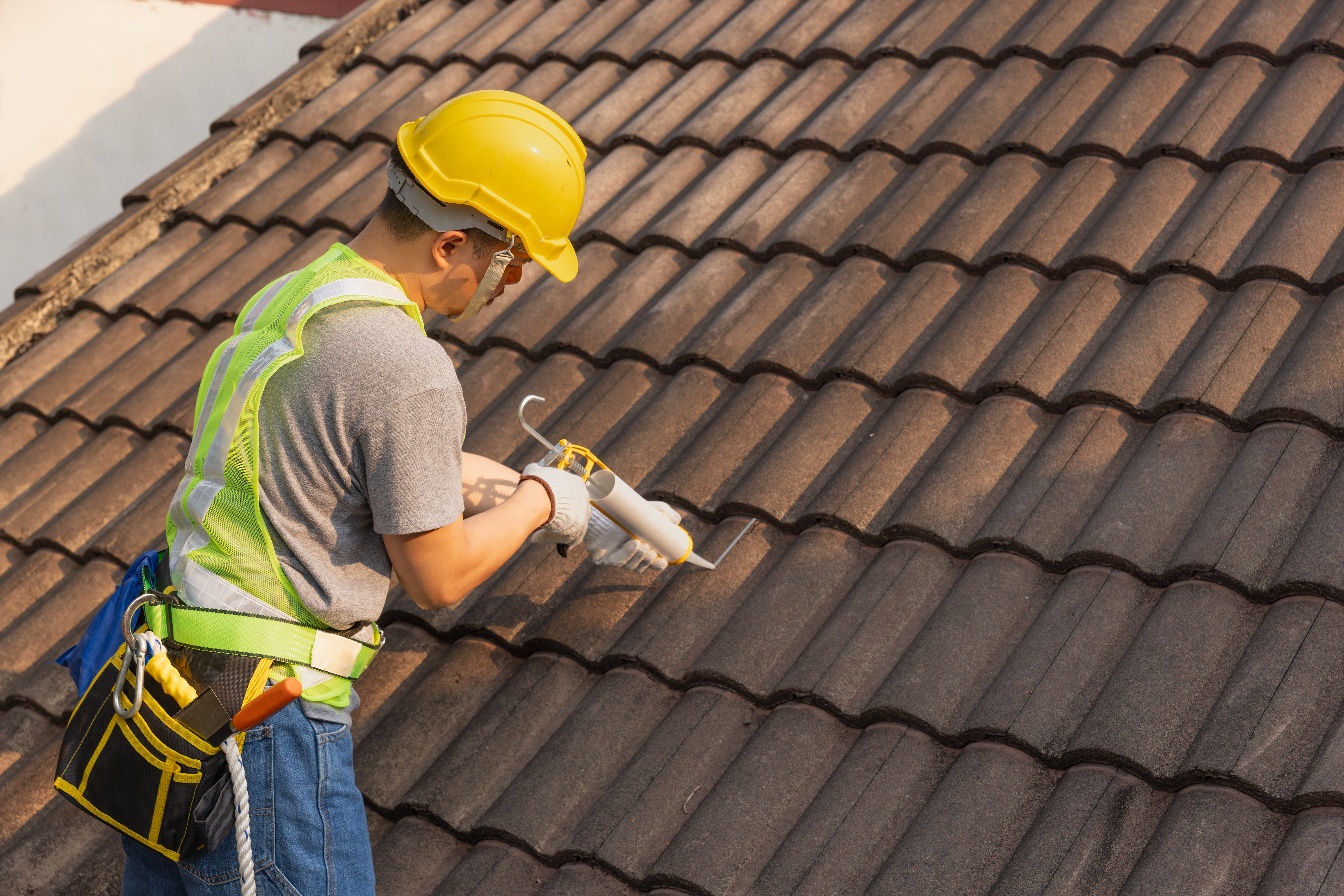 A professional working on repairing roof tiles 
