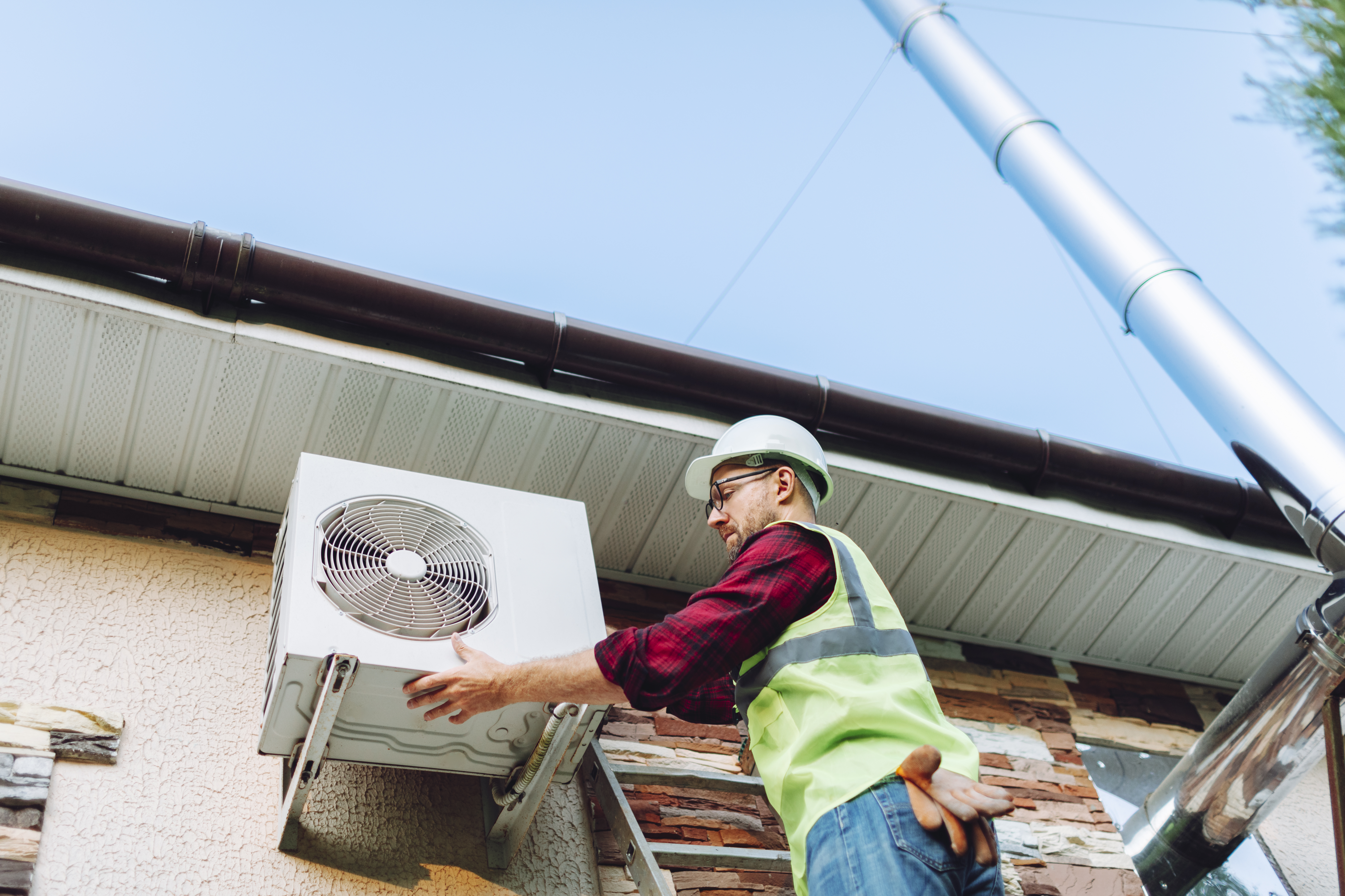 technician replacing ac