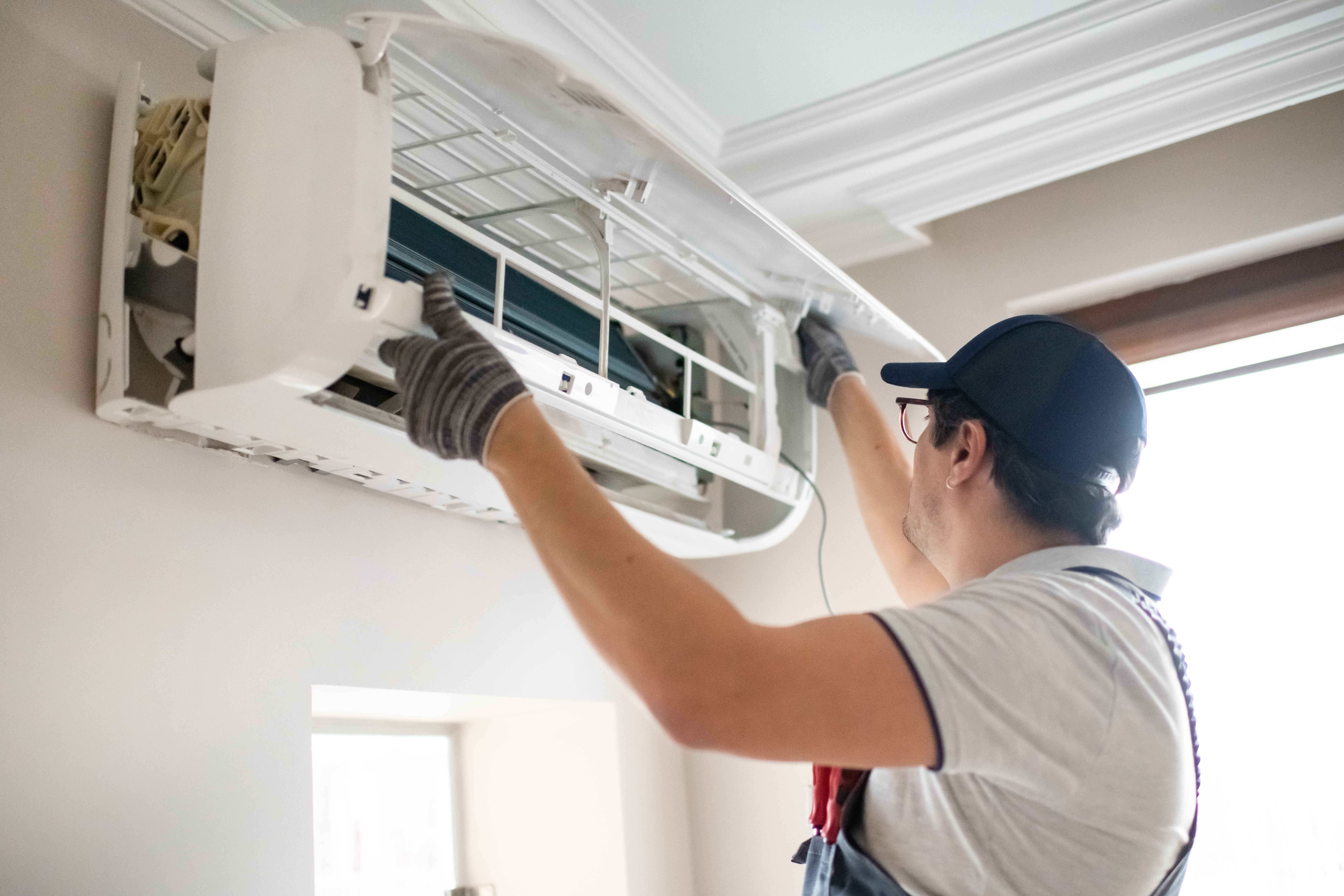 Technician repairing air conditioner