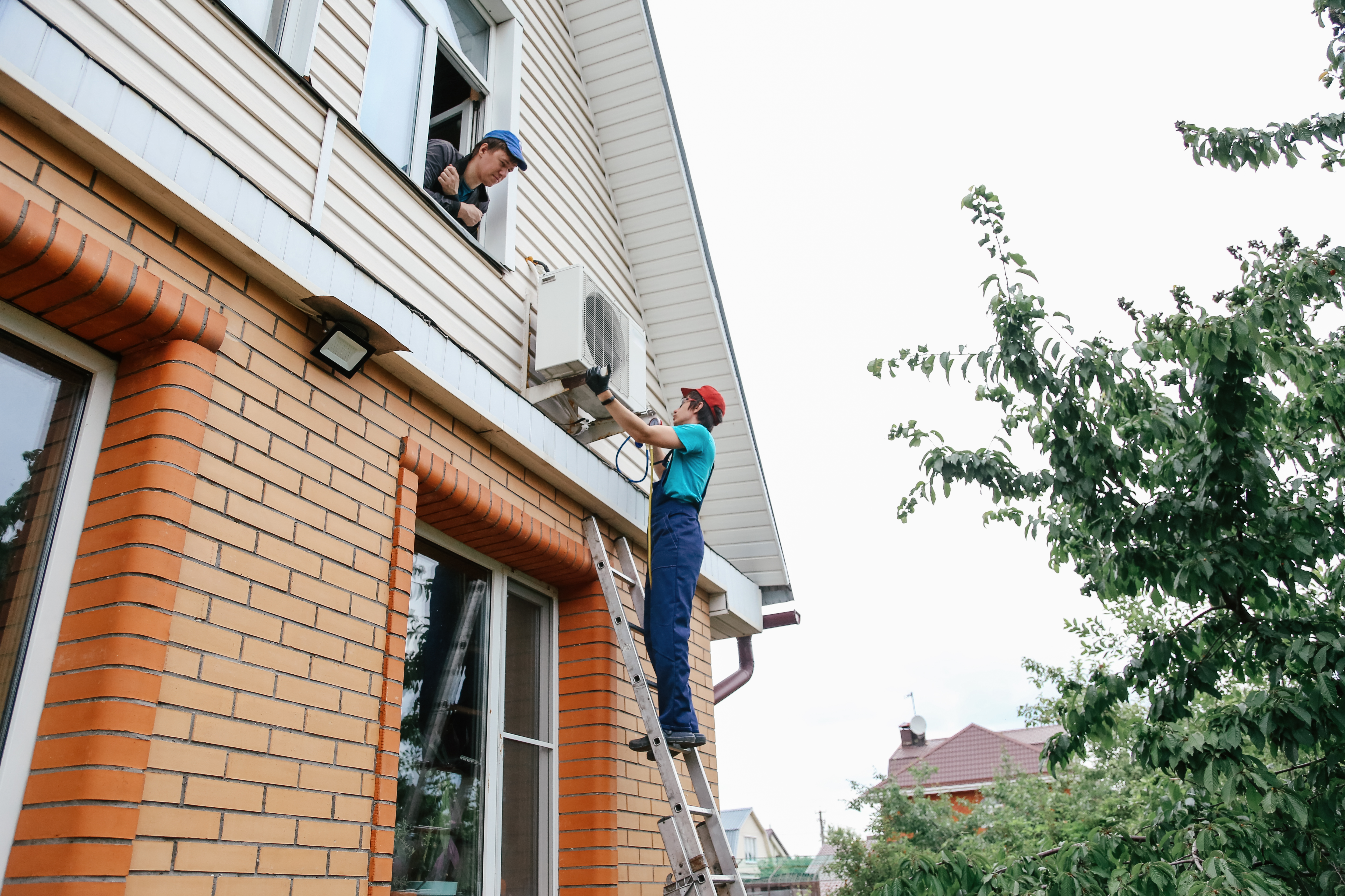 Worker repairing air conditioner