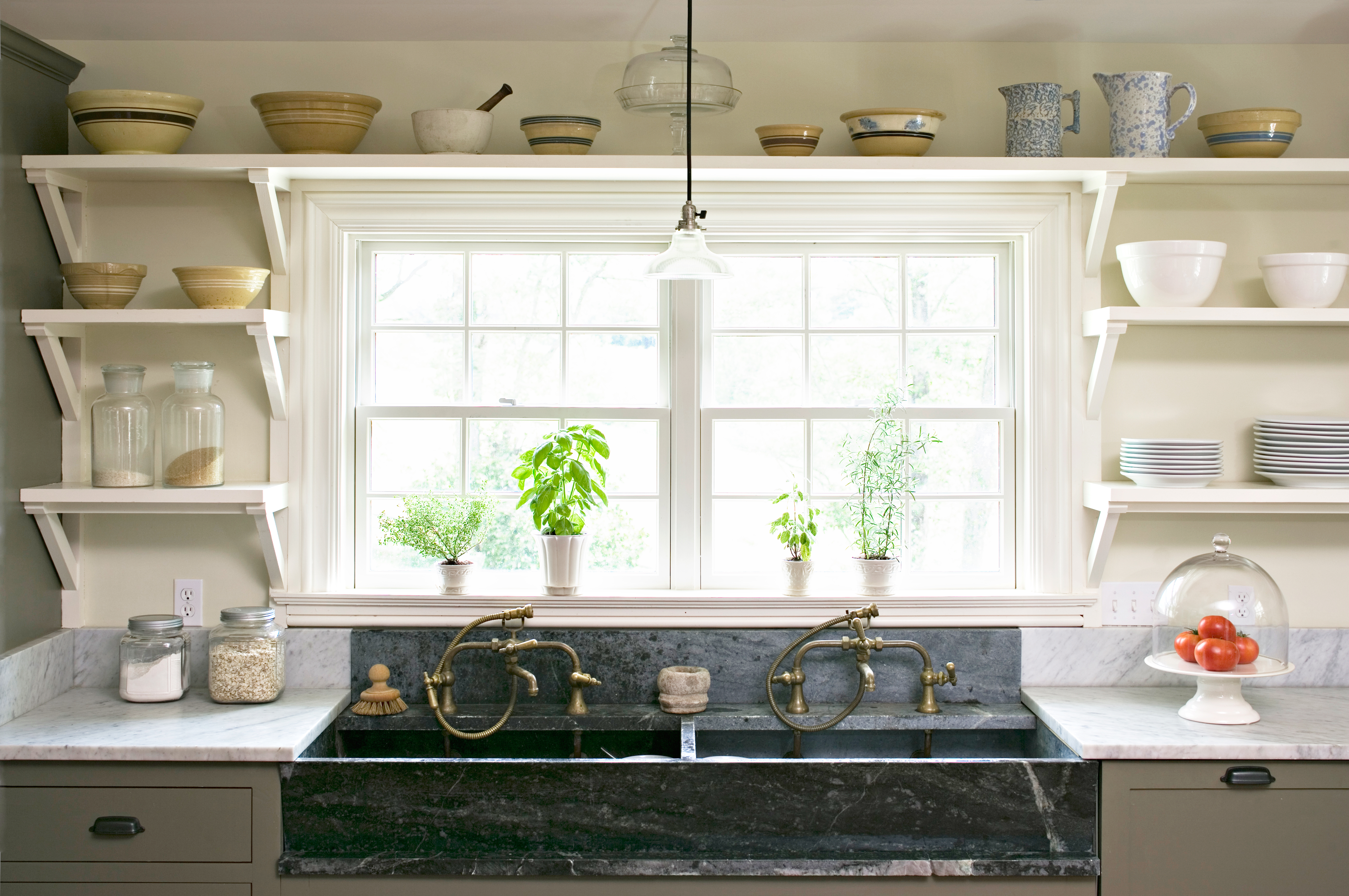 Open shelving surrounding a kitchen window