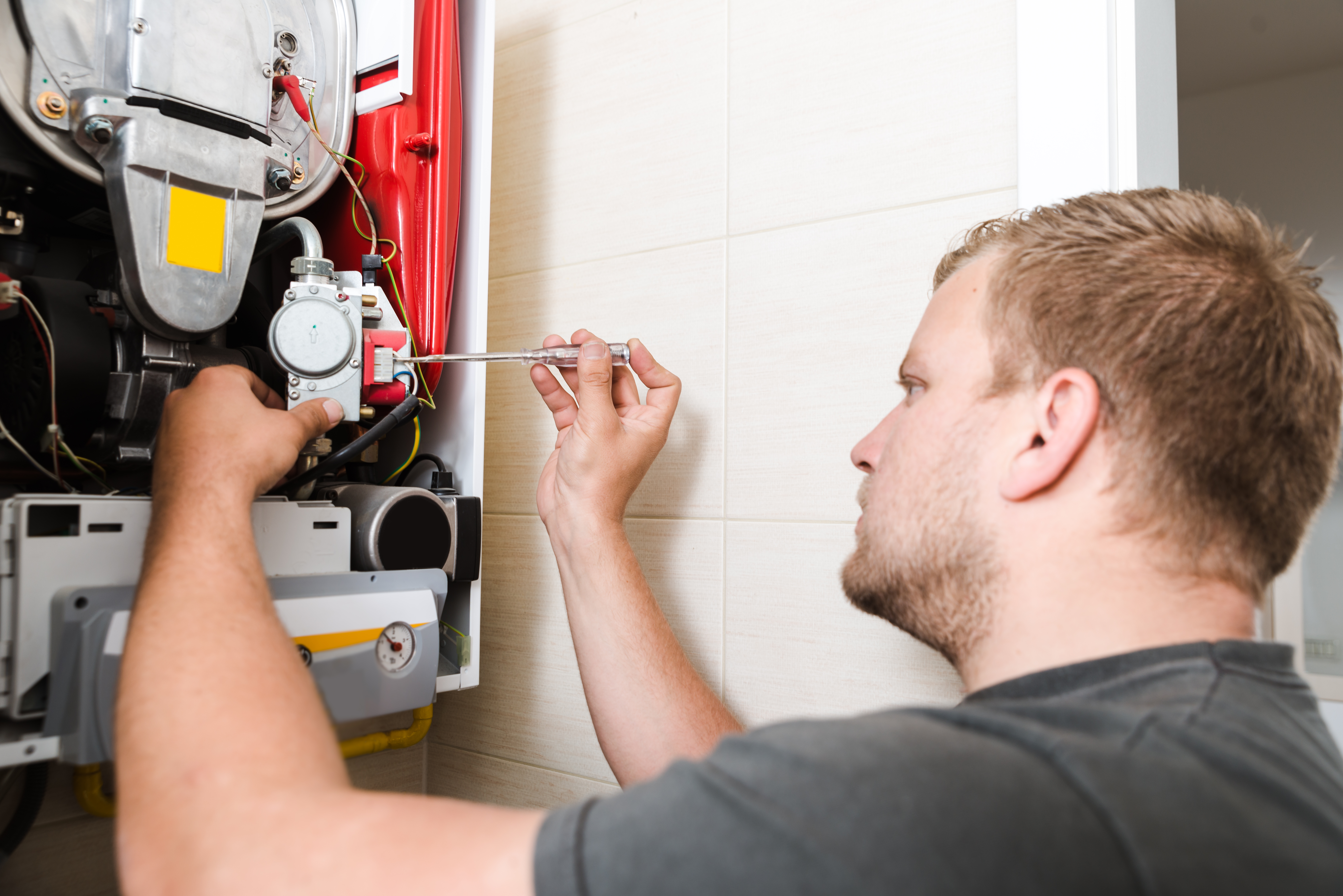 Technician repairing gas furnace