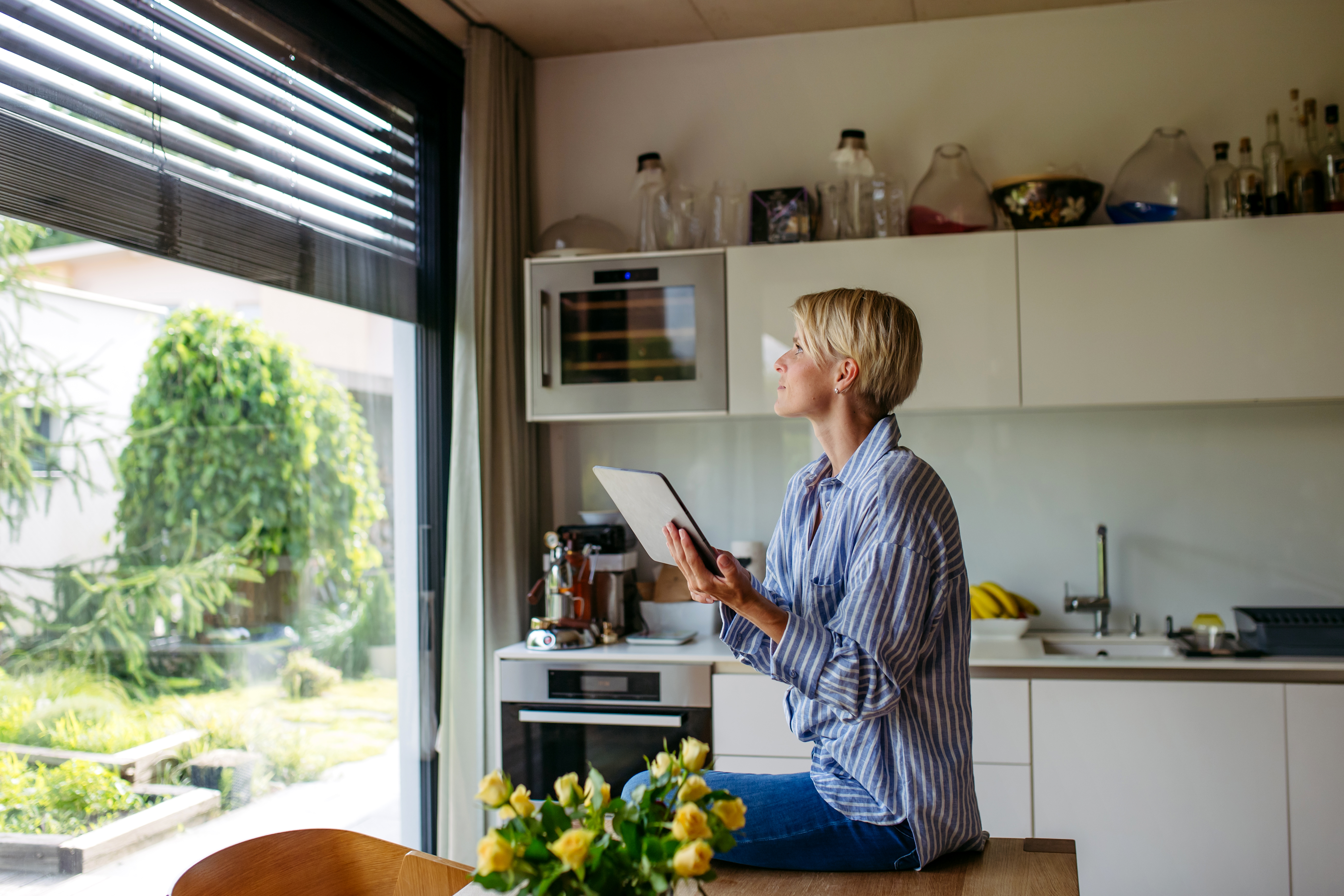 Woman closing metal blinds 