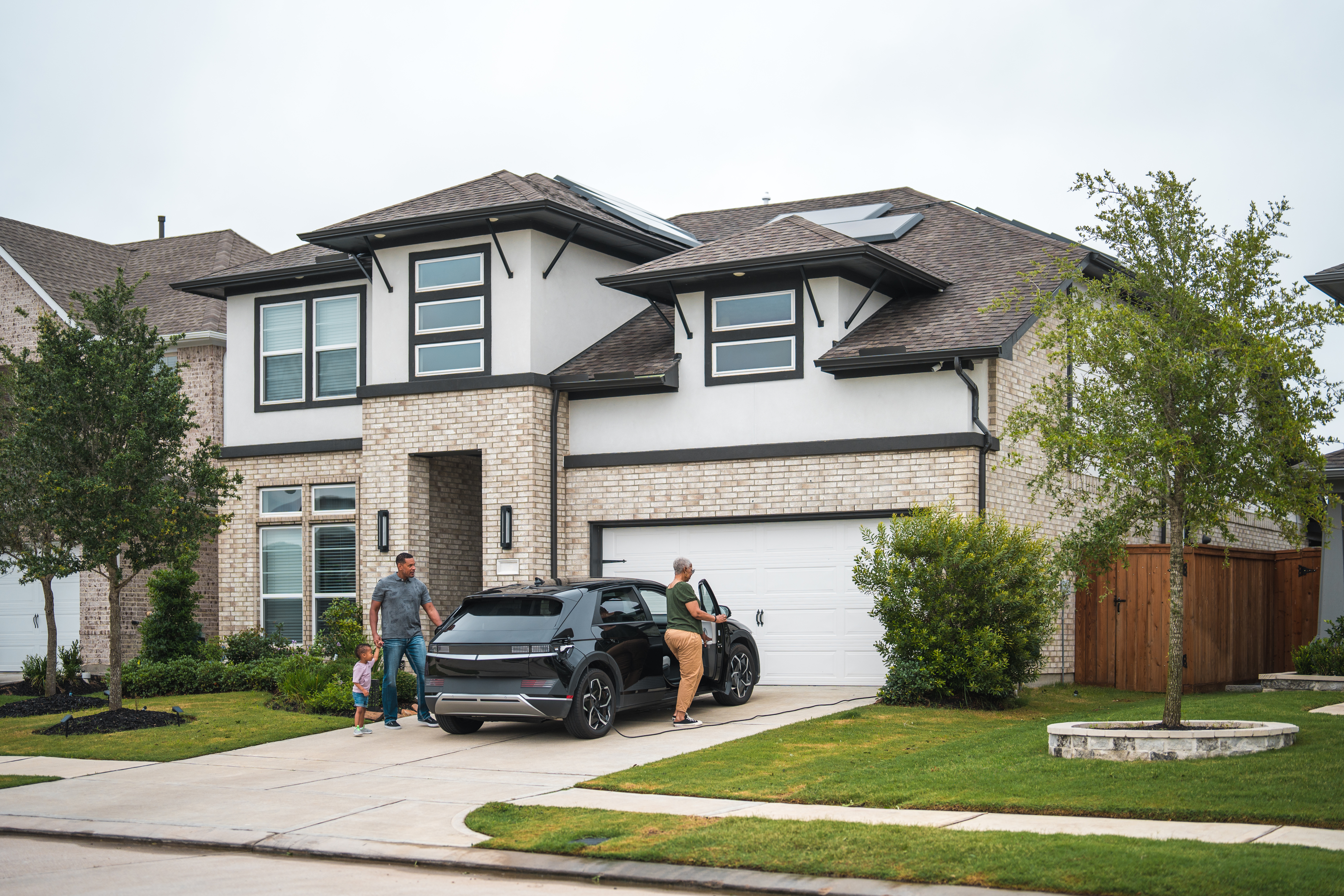 Family in front of a modern home