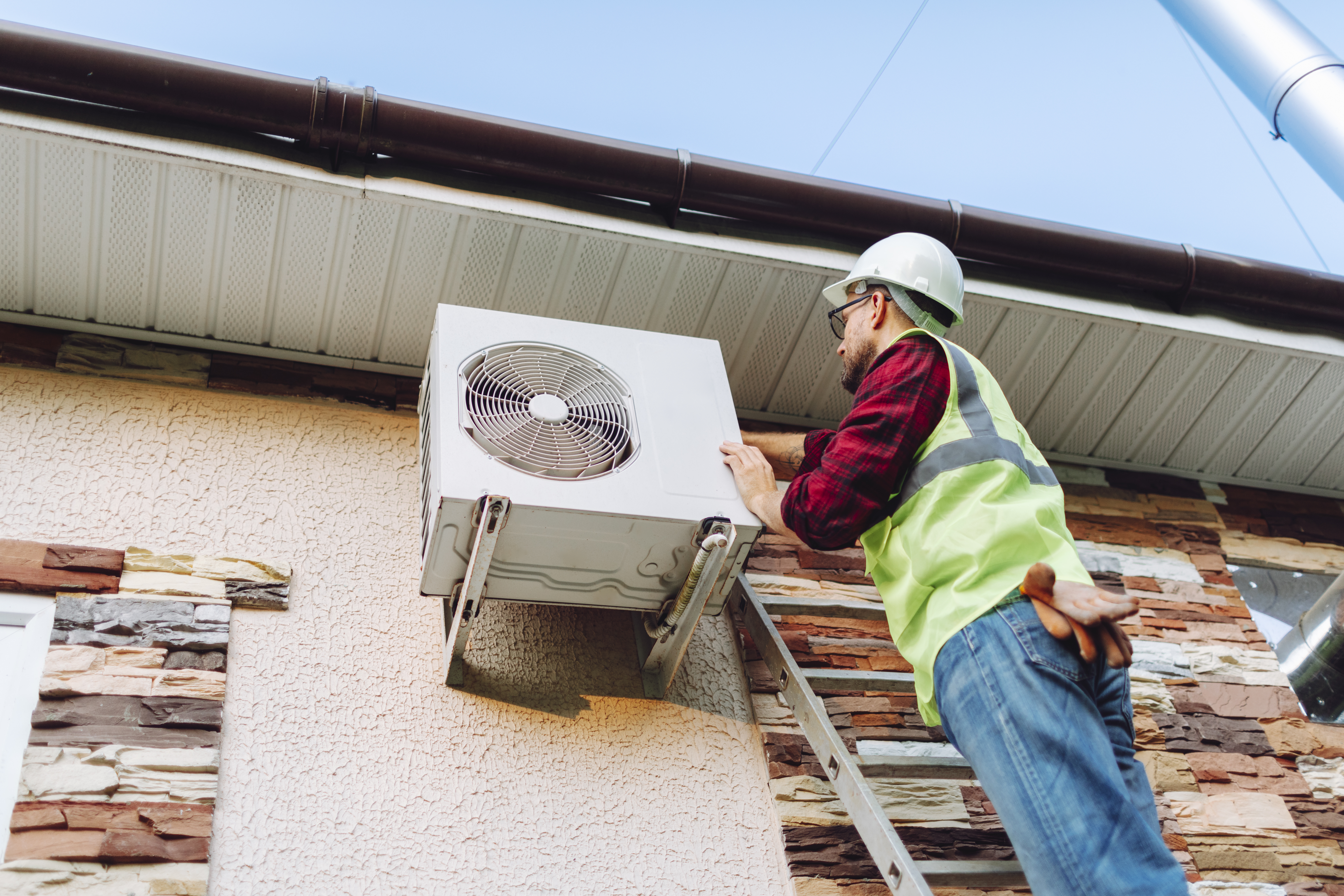 Technician repairing heat pump  