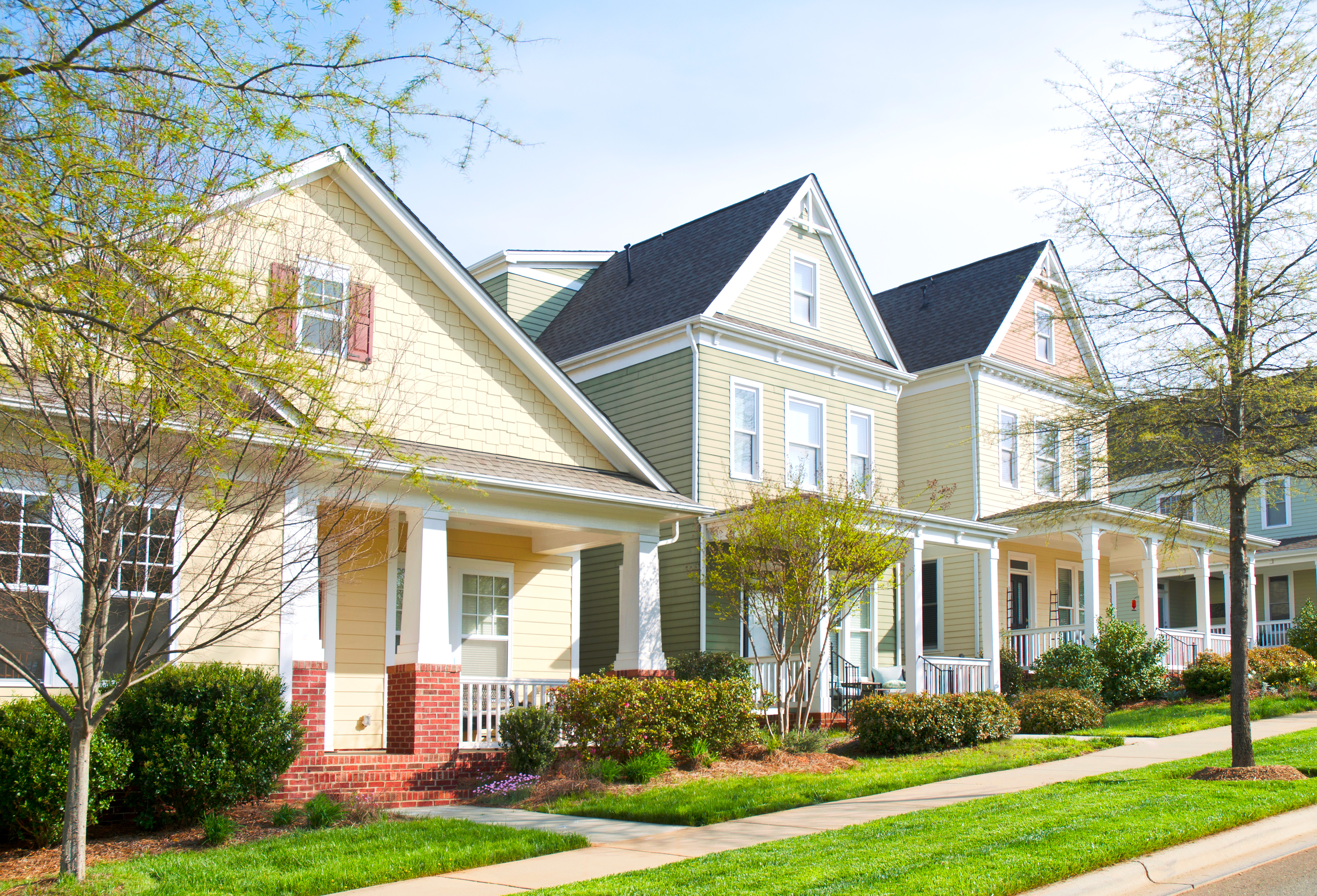 Row of houses with new vinyl siding and front porches  