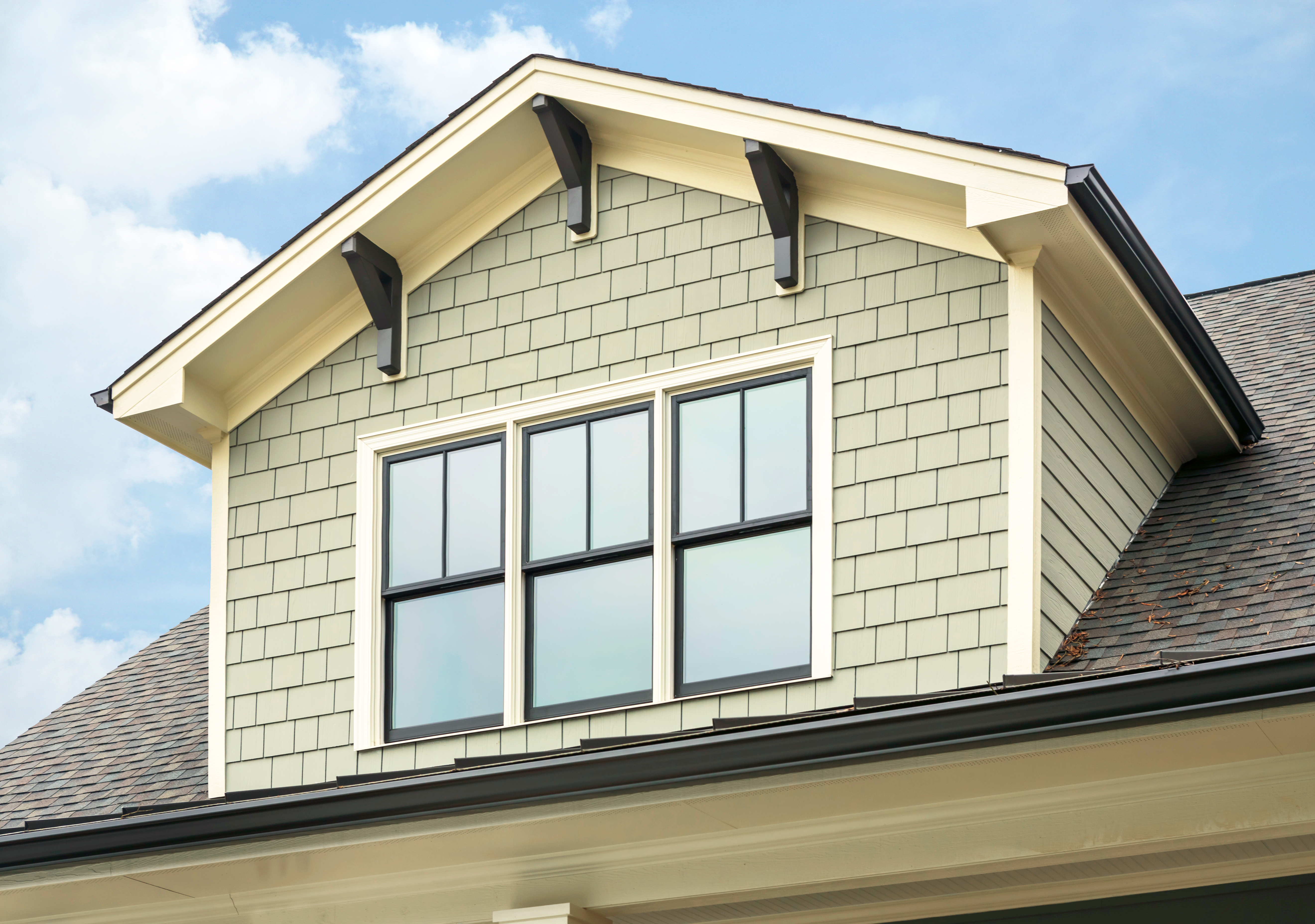 Vinyl shake siding installed on a dormer window