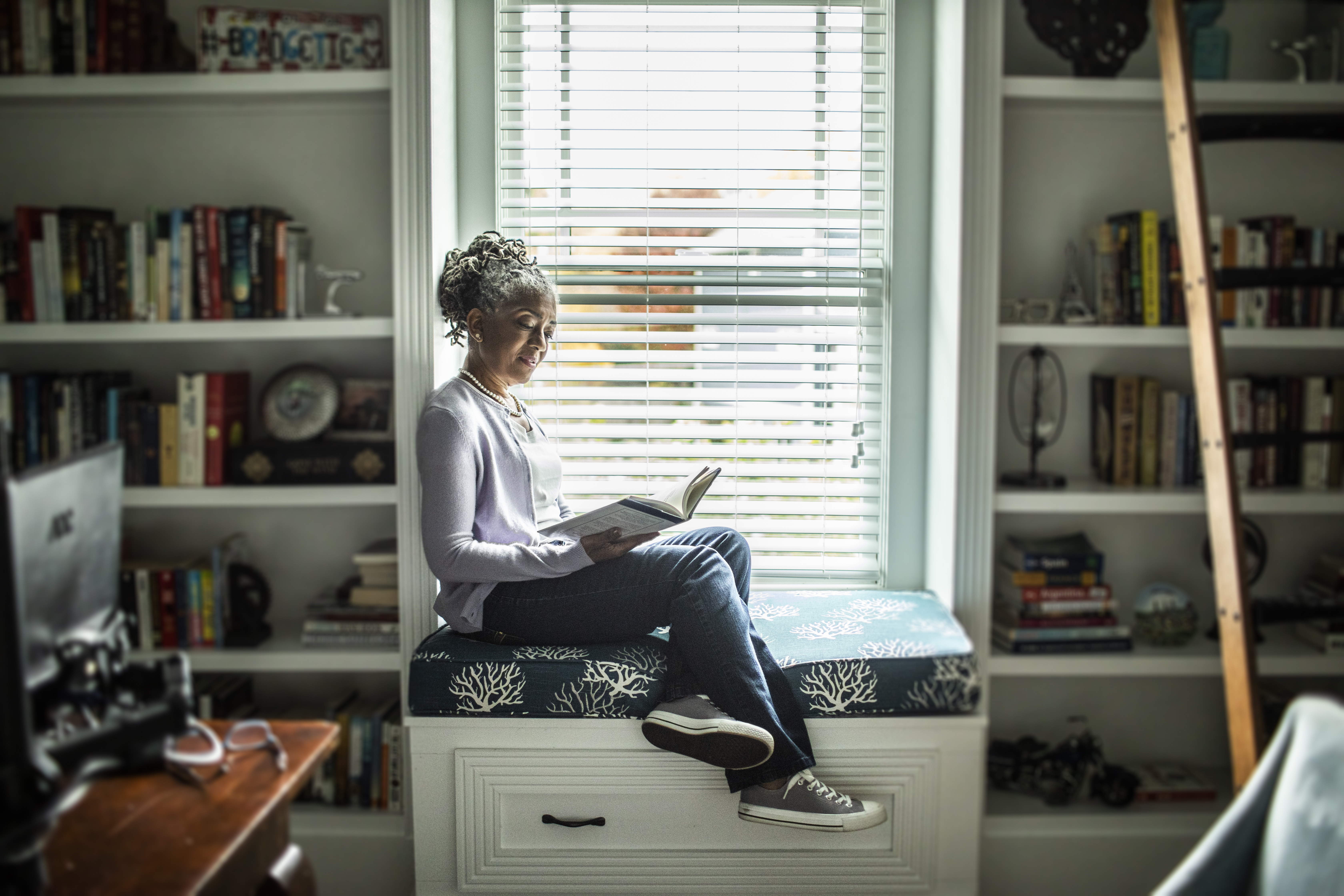 Woman reading in home library