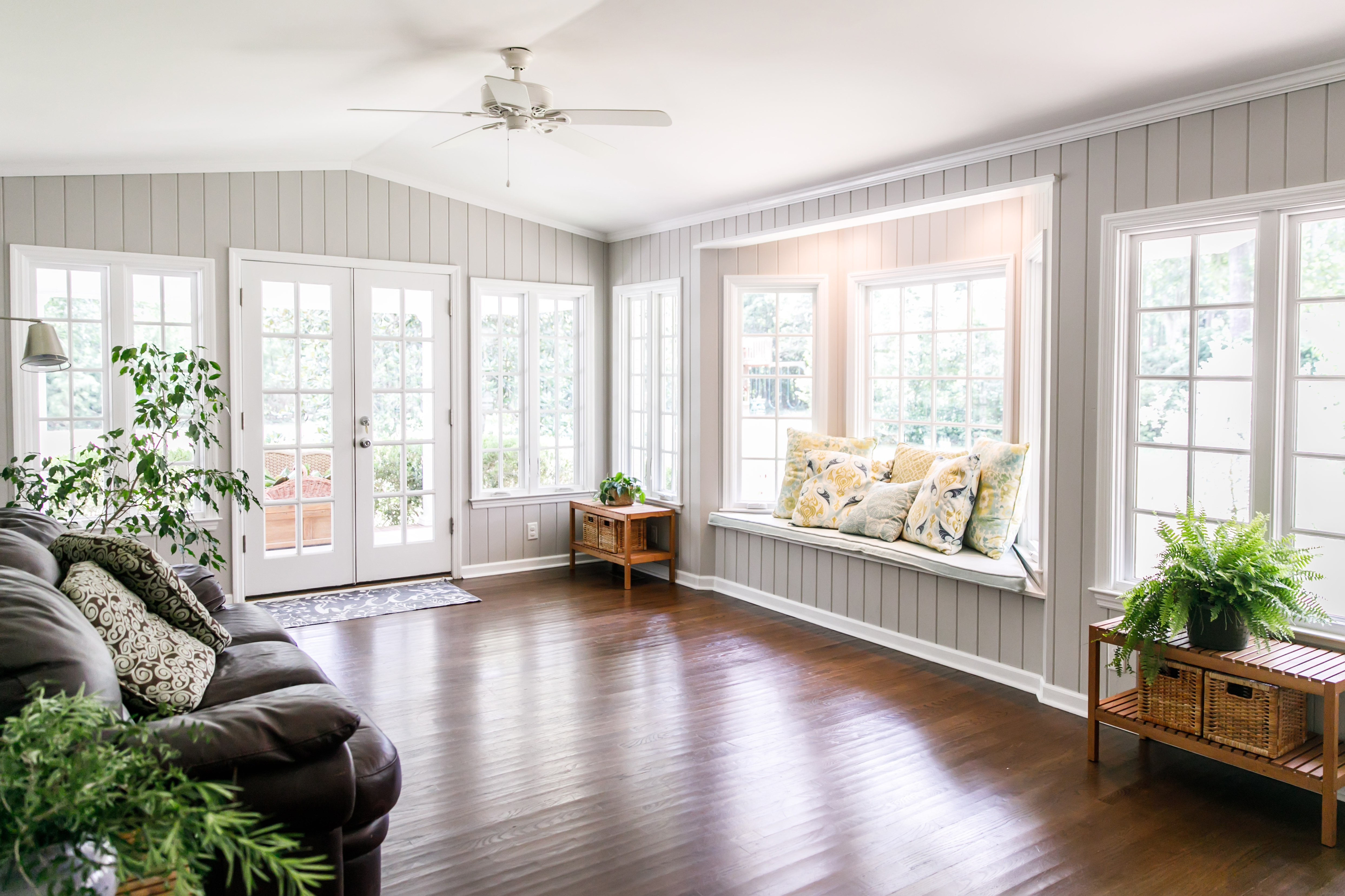 The interior of a bright living room with large windows 