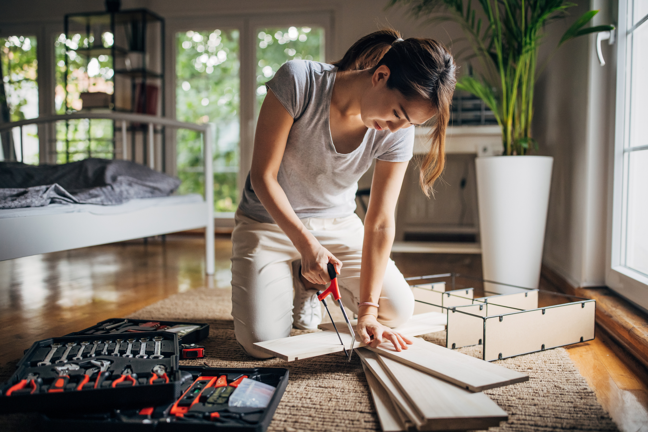 woman DIY assembling shelf at home