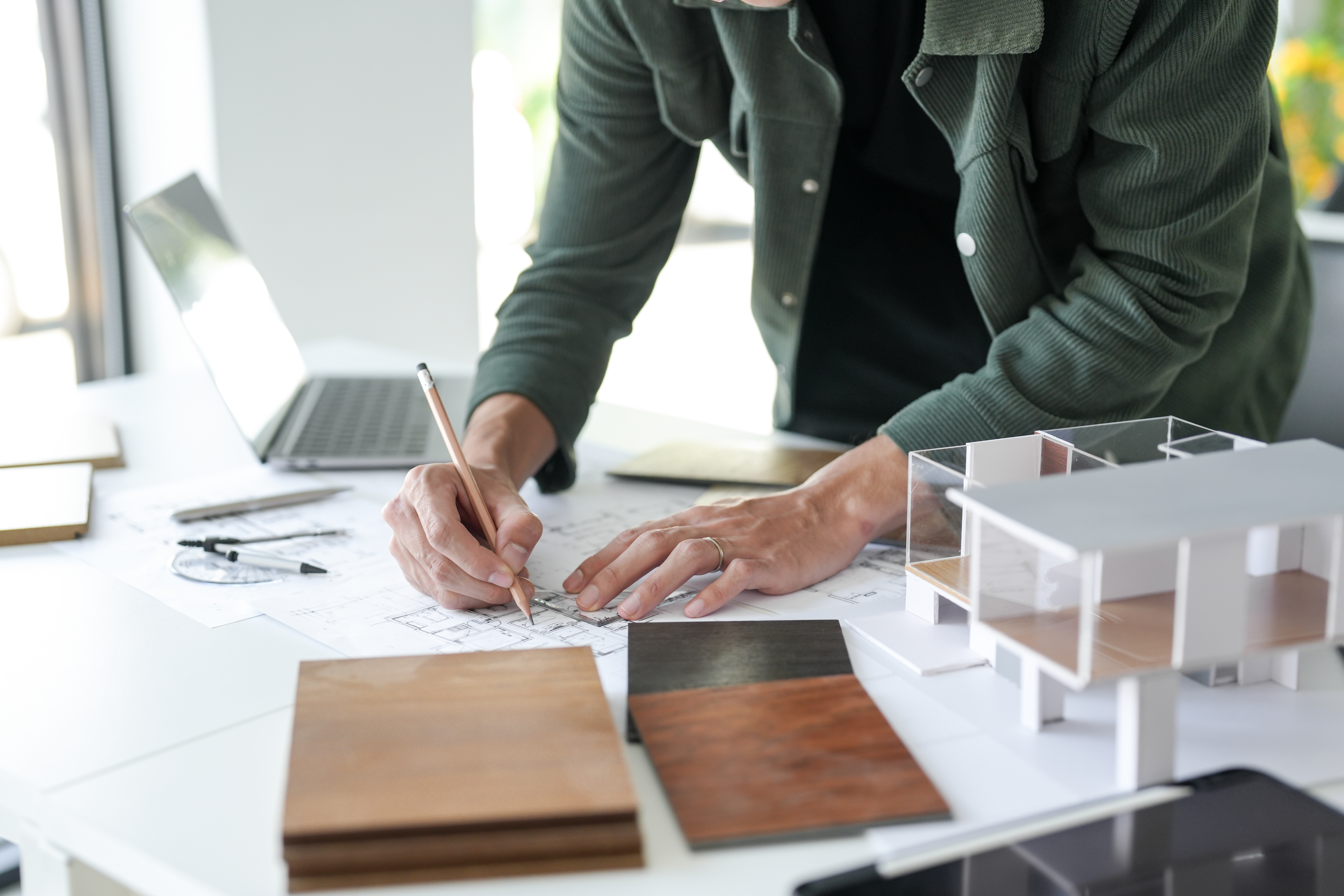 An architect designing kitchen blueprints