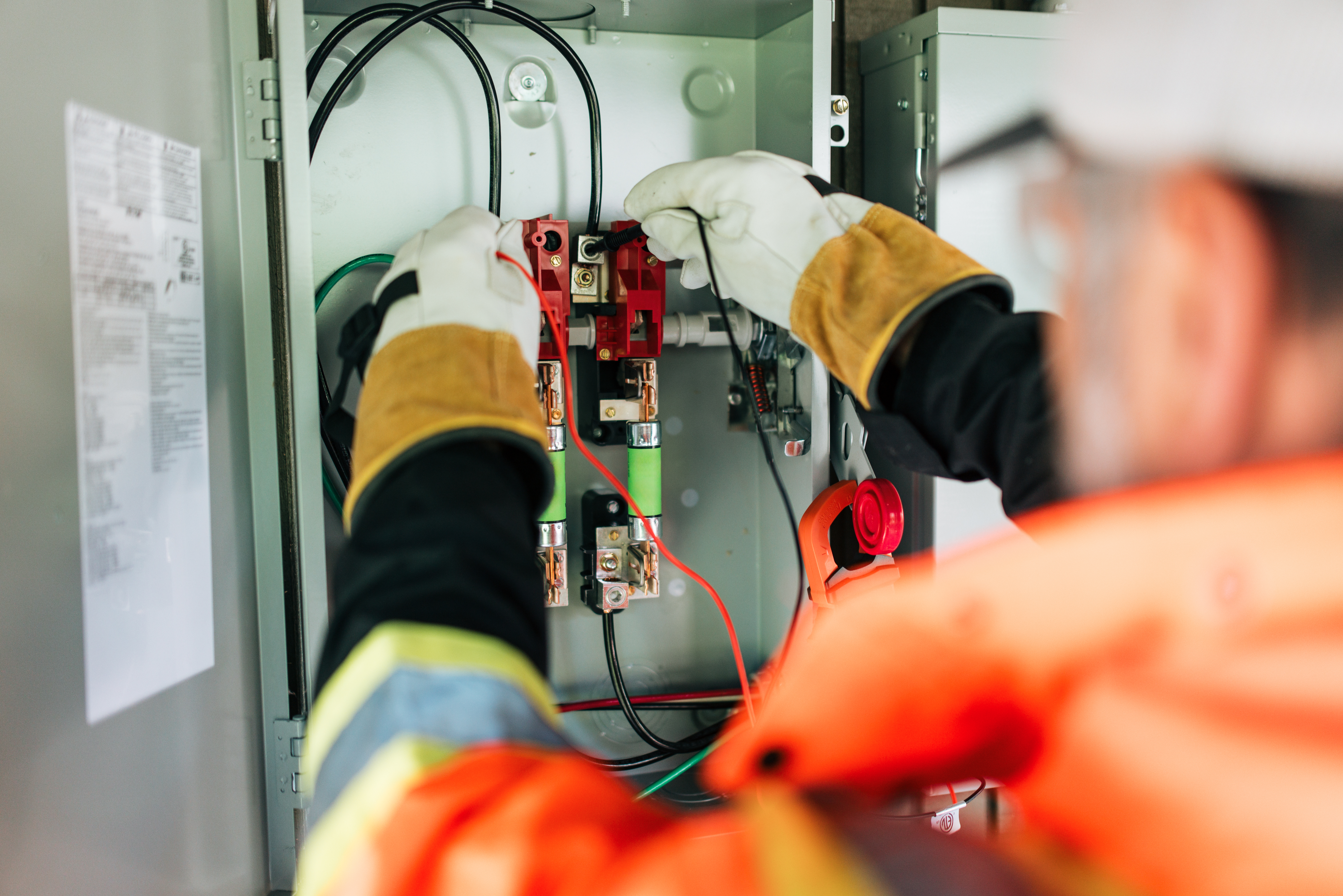 An electrician installing an electrical box
