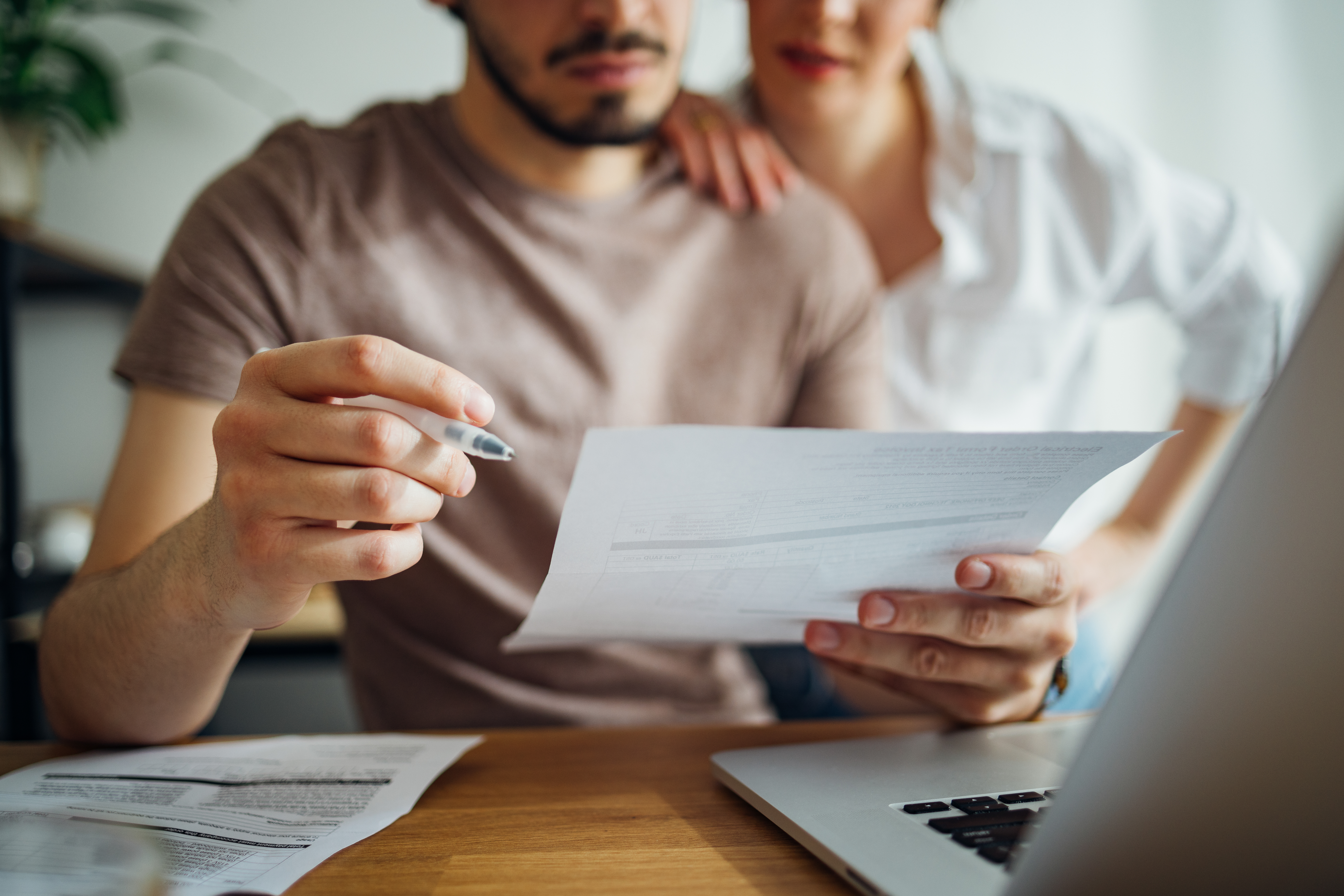 Couple paying bills at home