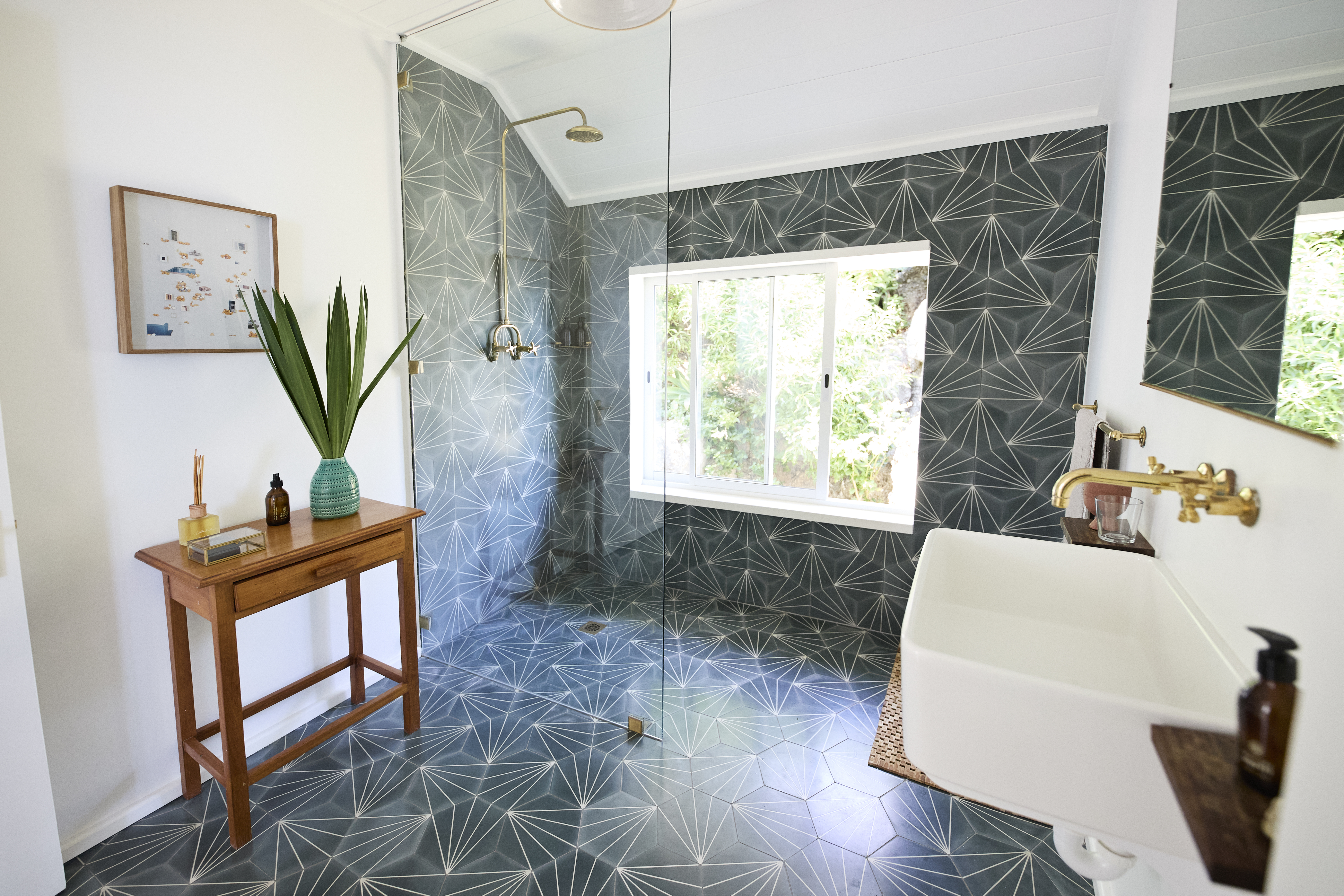 Modern bathroom with a curbless shower and green tile 